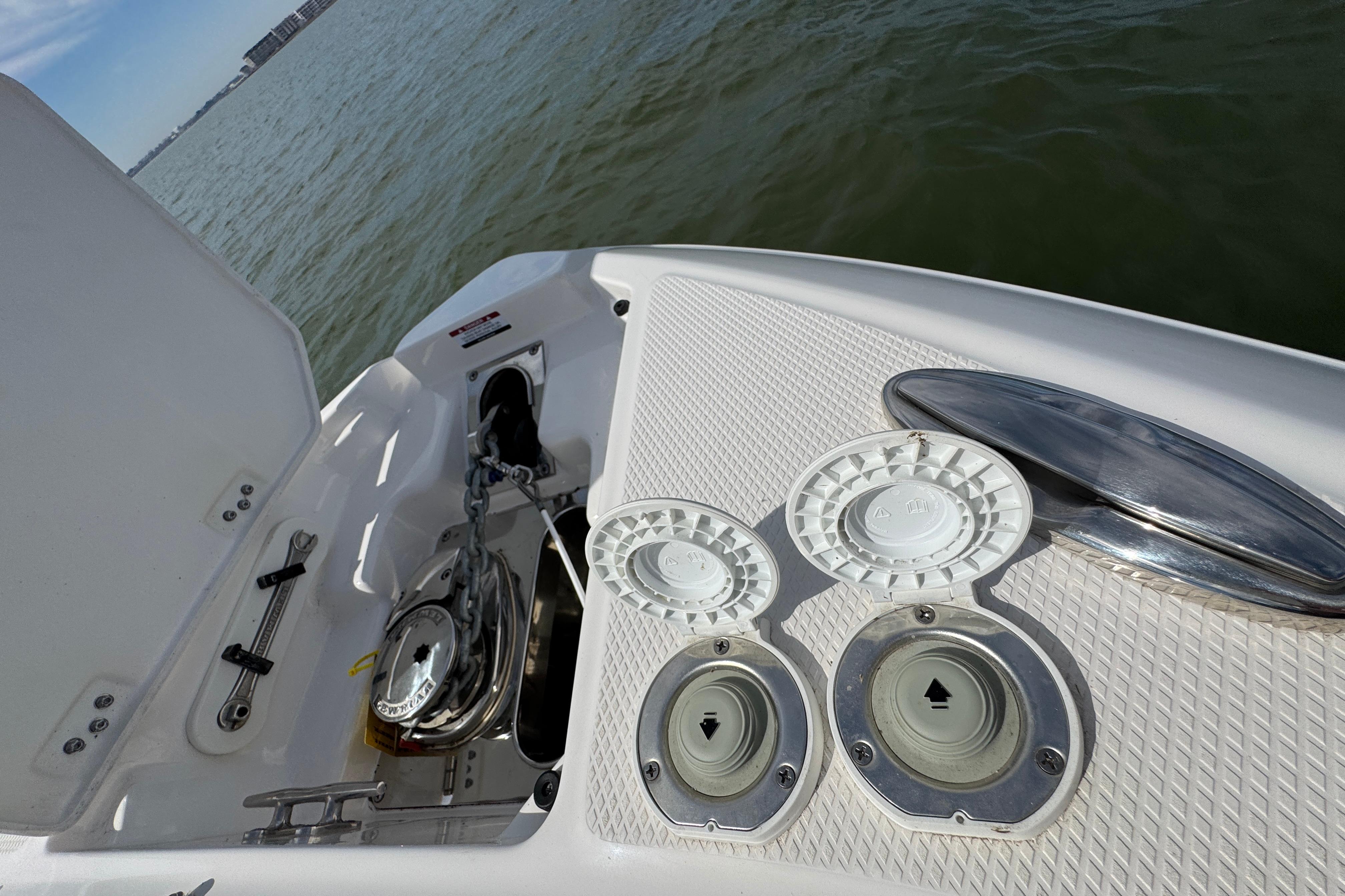 2023 Chaparral 26 Surf boat deck with anchor and hatch details.