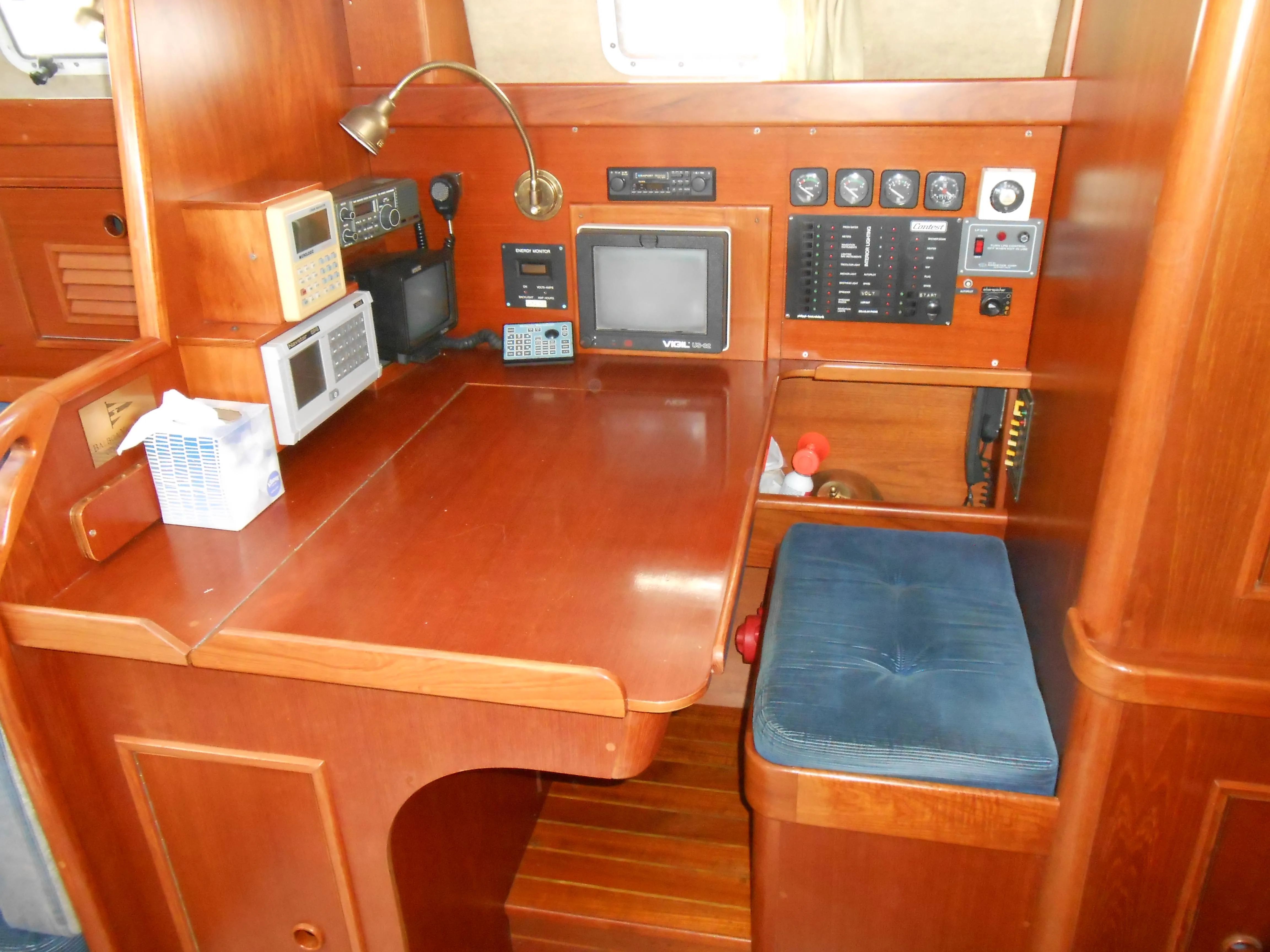 Navigation area of 1985 Contest 41 Ketch with wooden interior.
