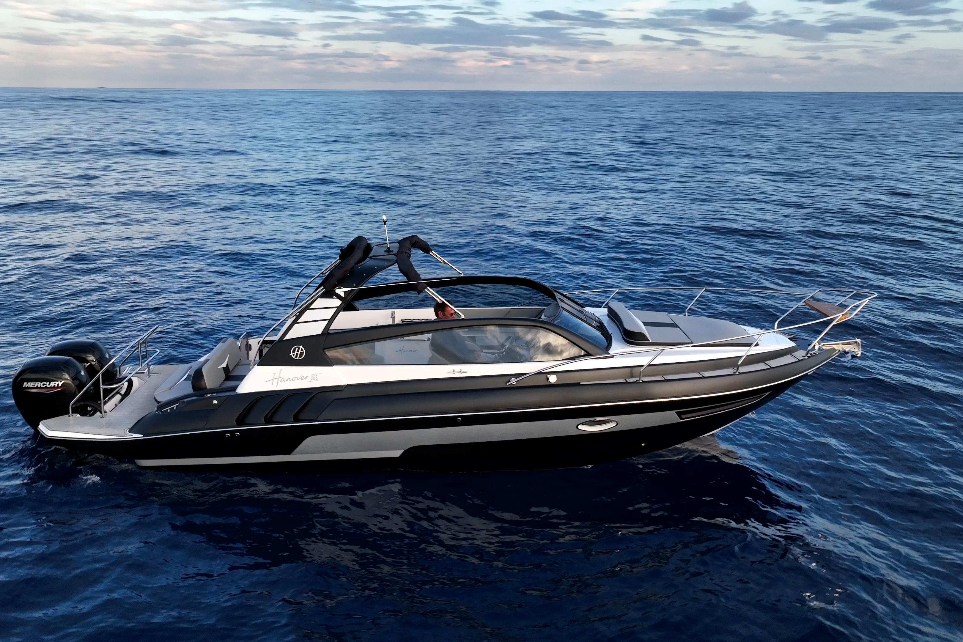 2027 Hanover 305 boat cruising on open sea under a partly cloudy sky.