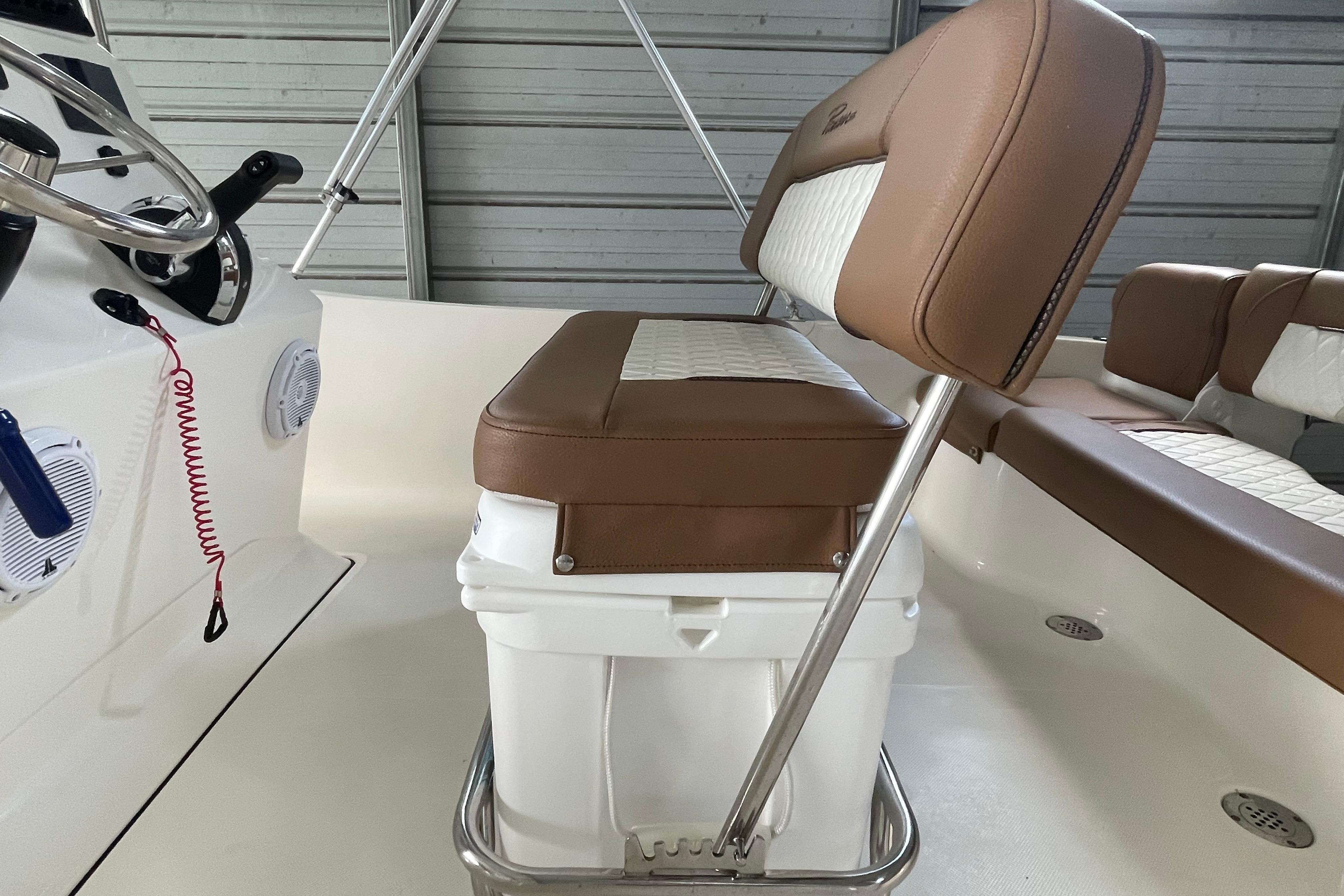 2024 Pioneer 180 Islander boat interior with cushioned seating and steering wheel.