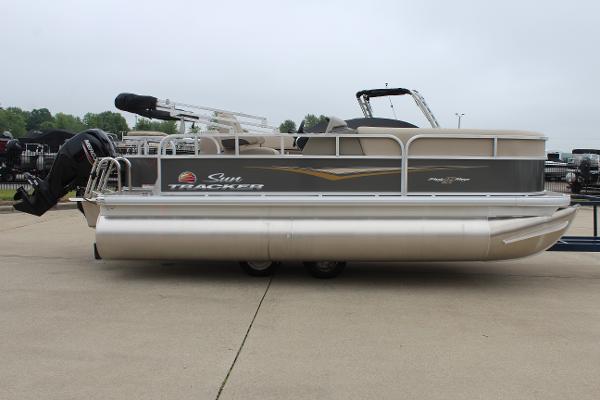 2025 Sun Tracker Party Barge 18 DLX pontoon boat on a concrete surface.