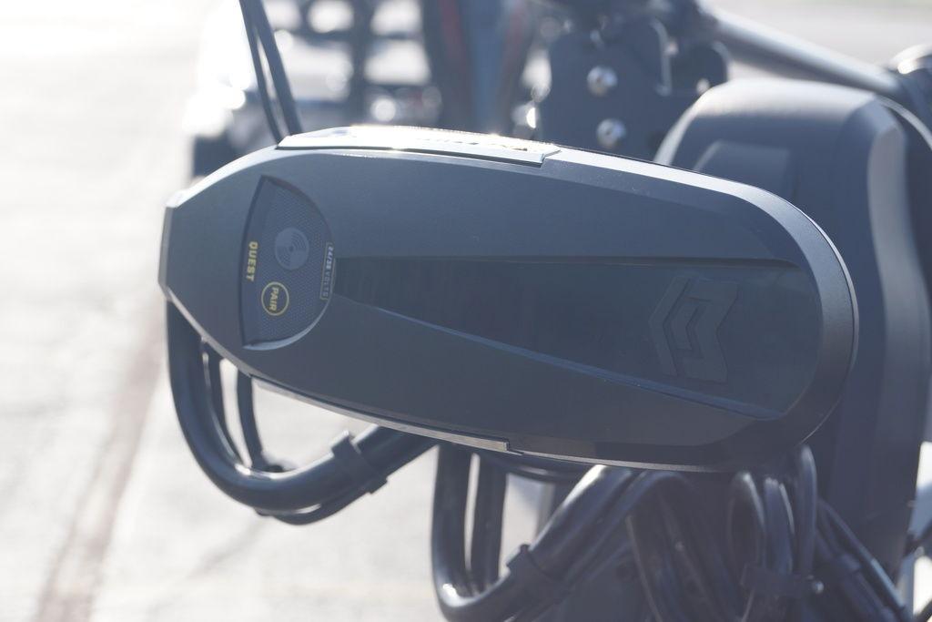Close-up of a 2025 Phoenix 921 Elite boat motor component in sunlight.