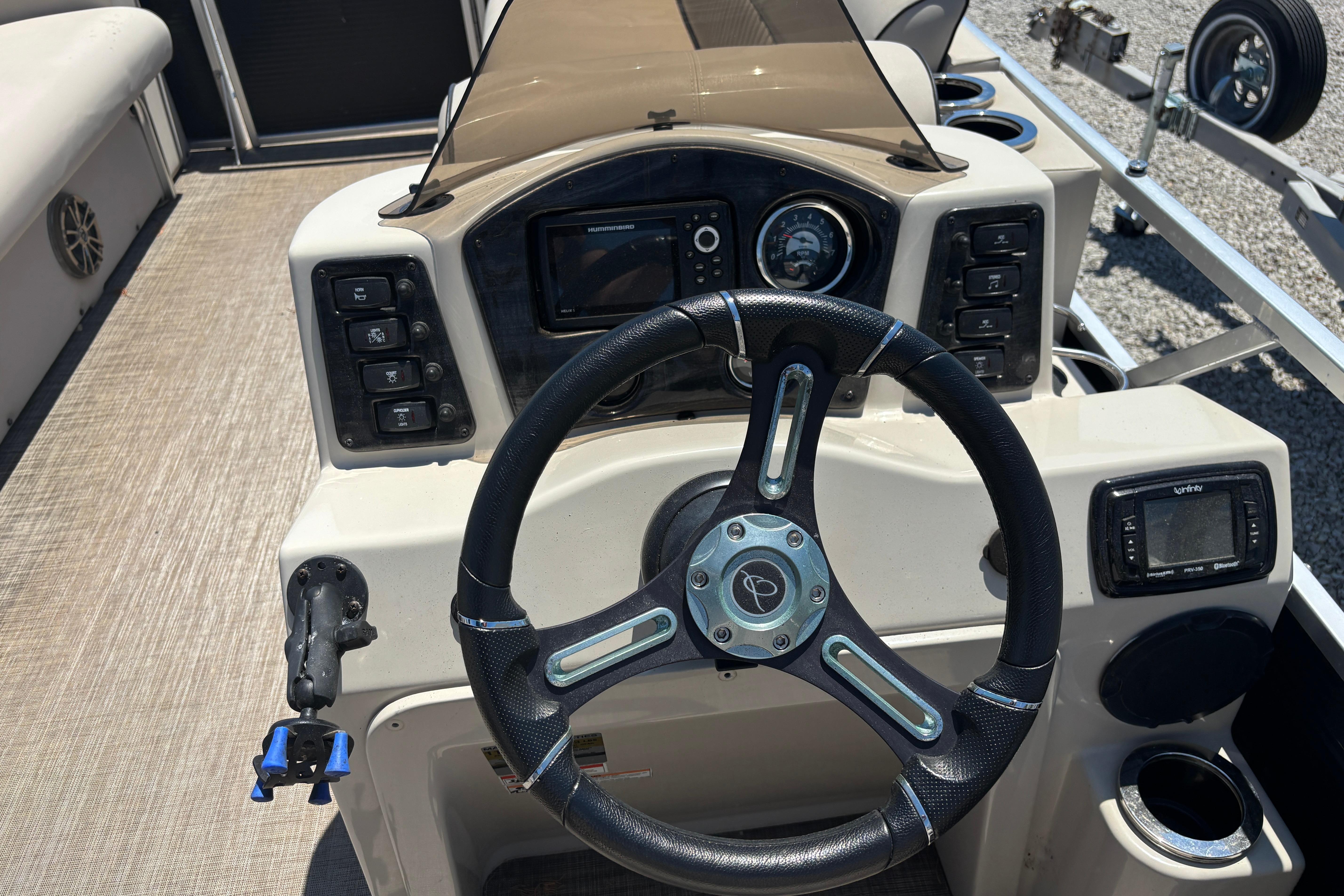 Steering console of 2017 Qwest LS 822 Bar pontoon boat with control panel and gauges.