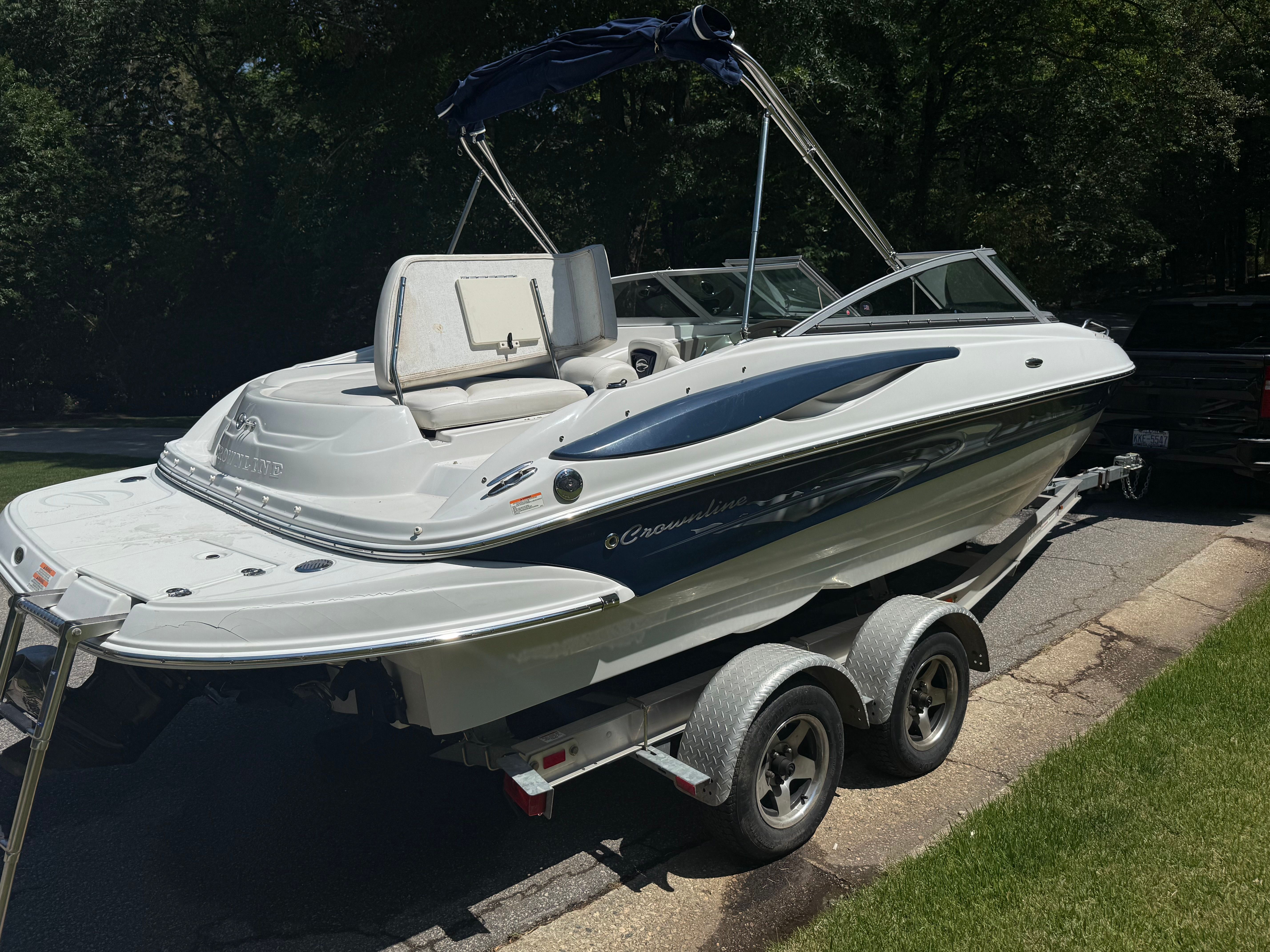 2008 Crownline 210 LX boat parked on trailer outdoors.