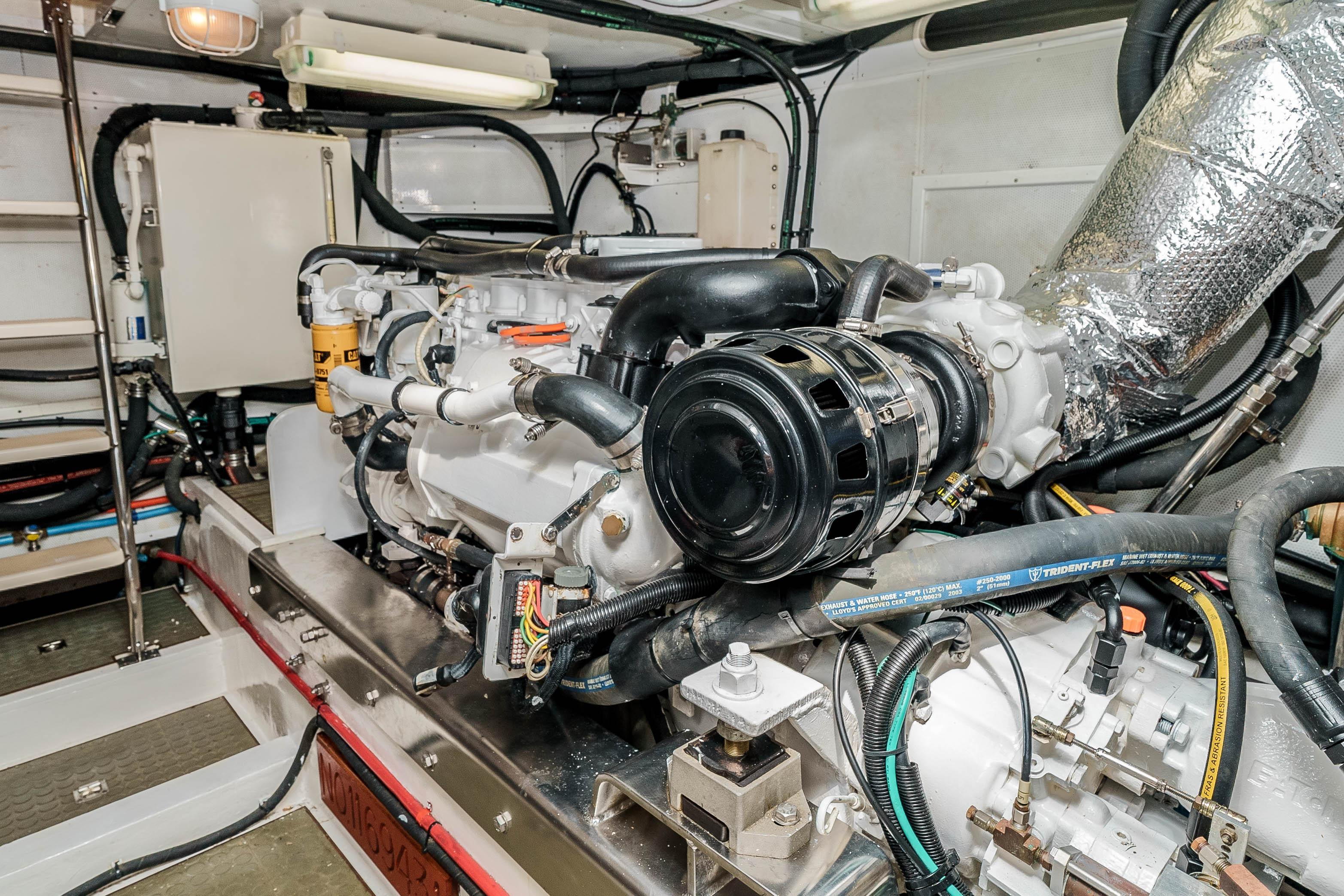 Engine room of 2005 Offshore Yachts 54 Pilothouse, showcasing detailed mechanical components.