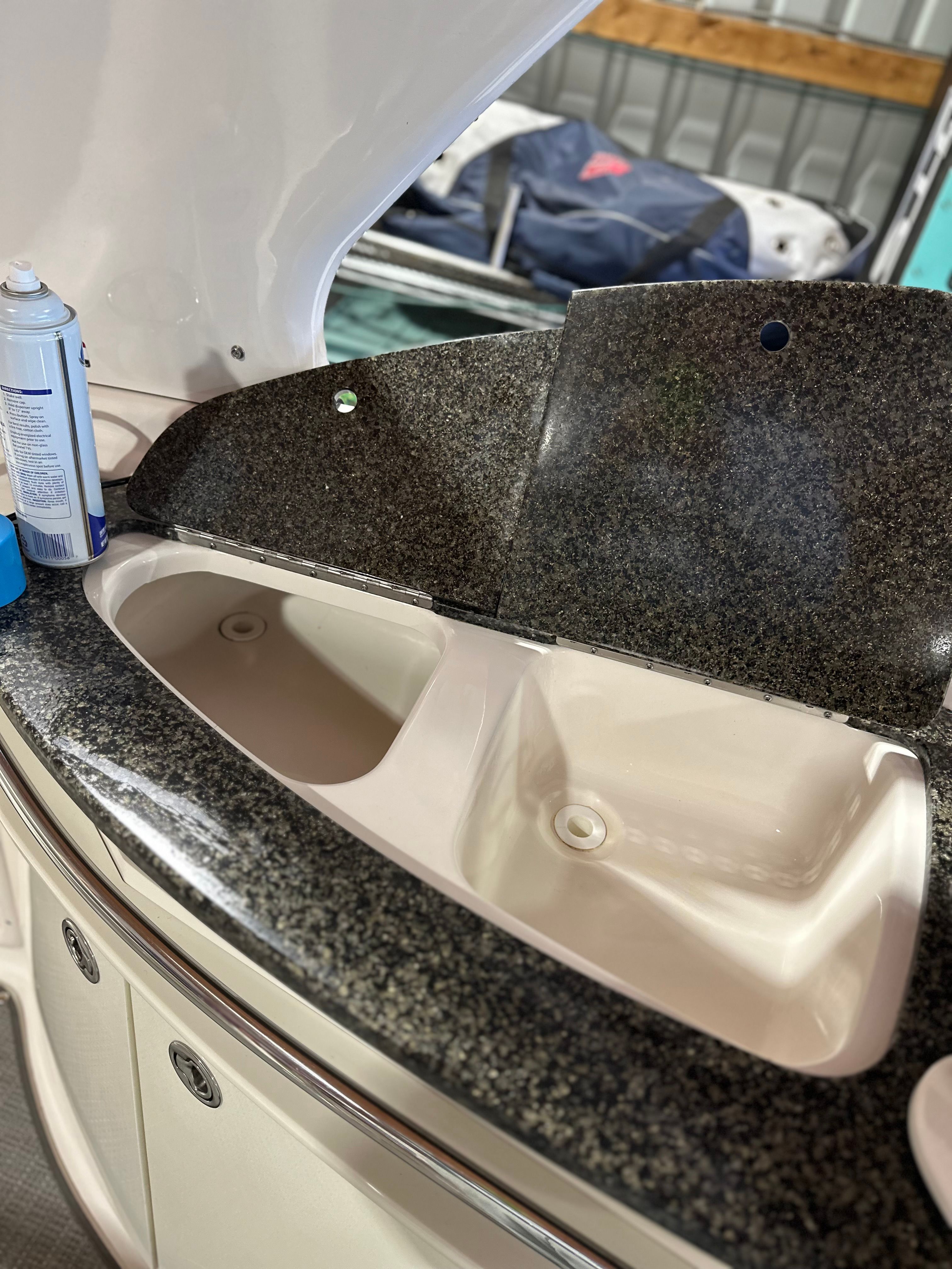 A sleek sink with a granite countertop on a boat.