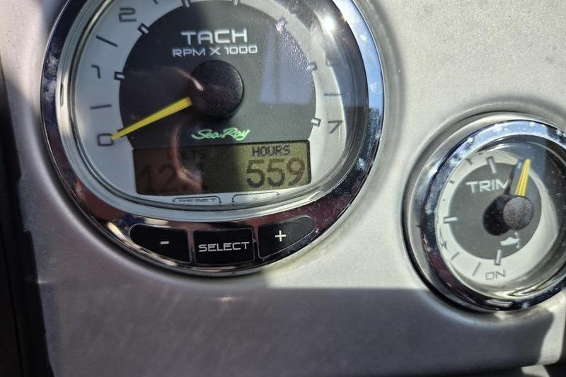 Tachometer and trim gauge on 2011 Sea Ray 300 Sundeck, showing 559 hours.