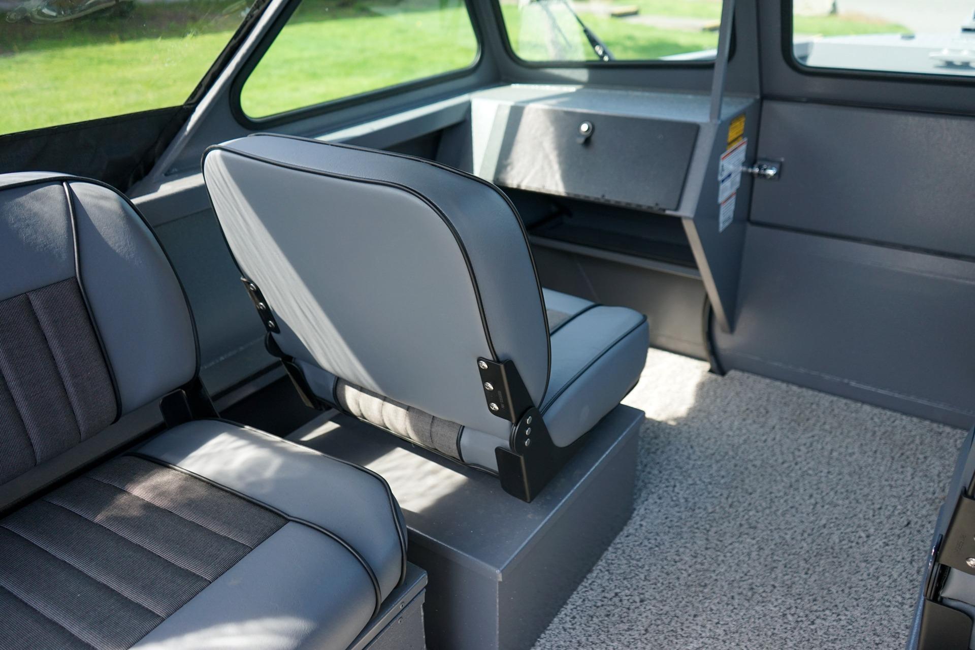 Interior of 2026 Alumaweld Talon 18 boat, featuring gray seating and carpeted flooring.