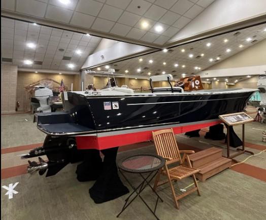 2024 C.W. Hood 26E Electric Runabout displayed indoors, showcasing sleek design and modern features.