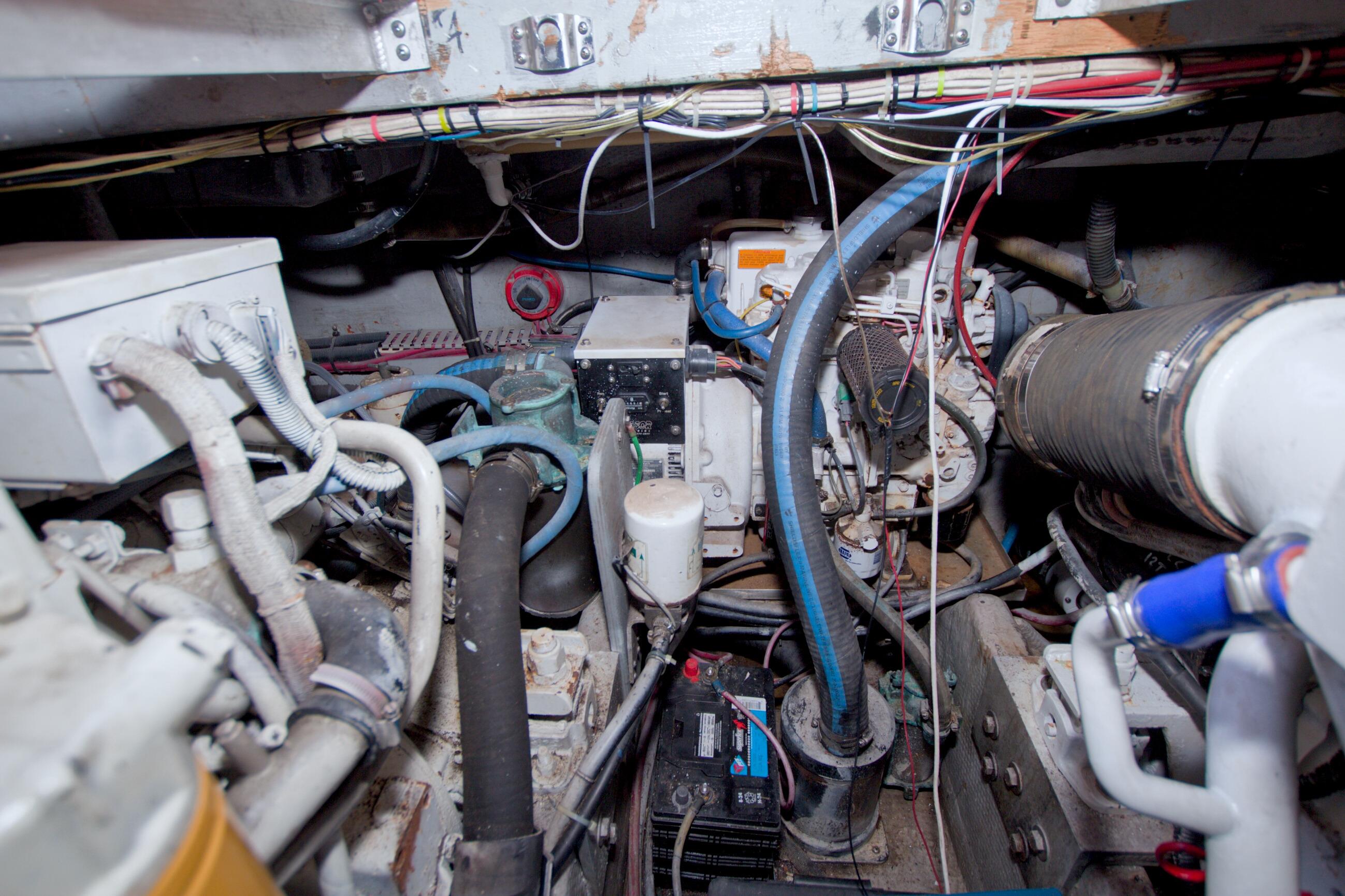 Engine room of a 1998 Luhrs 36 Convertible boat, showcasing mechanical components and wiring.