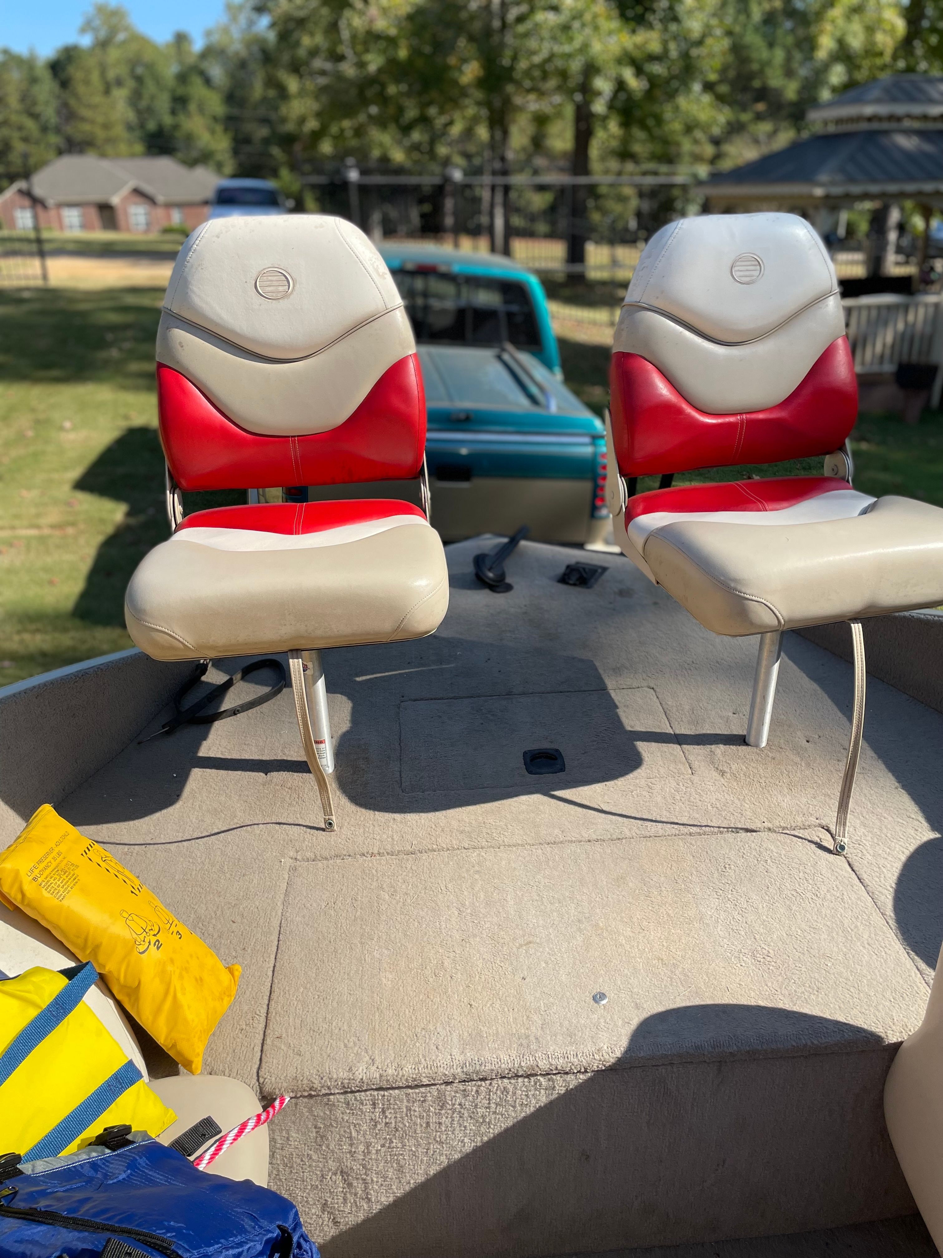 2005 Sun Tracker Party Deck 21 I/O with red and beige seats.