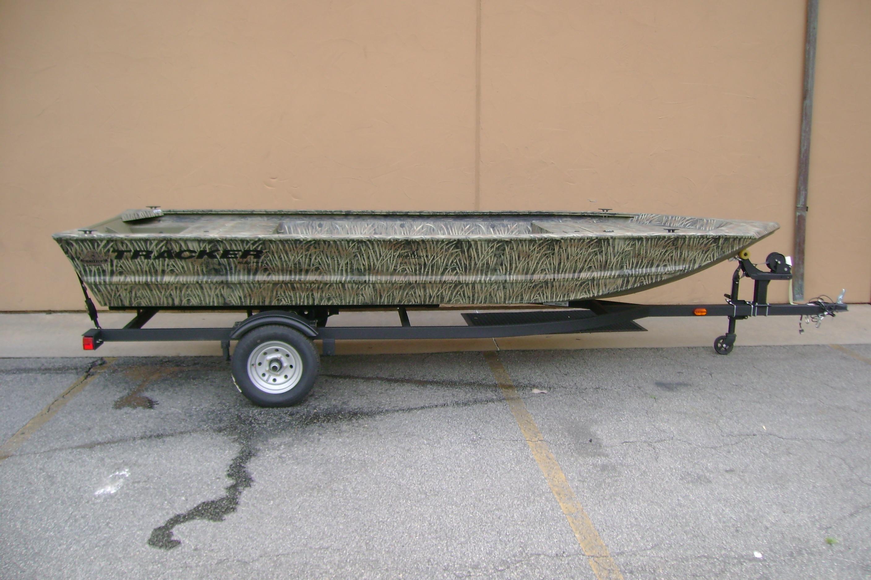 2026 Tracker Grizzly 1648 Utility boat on trailer, featuring camouflage design.