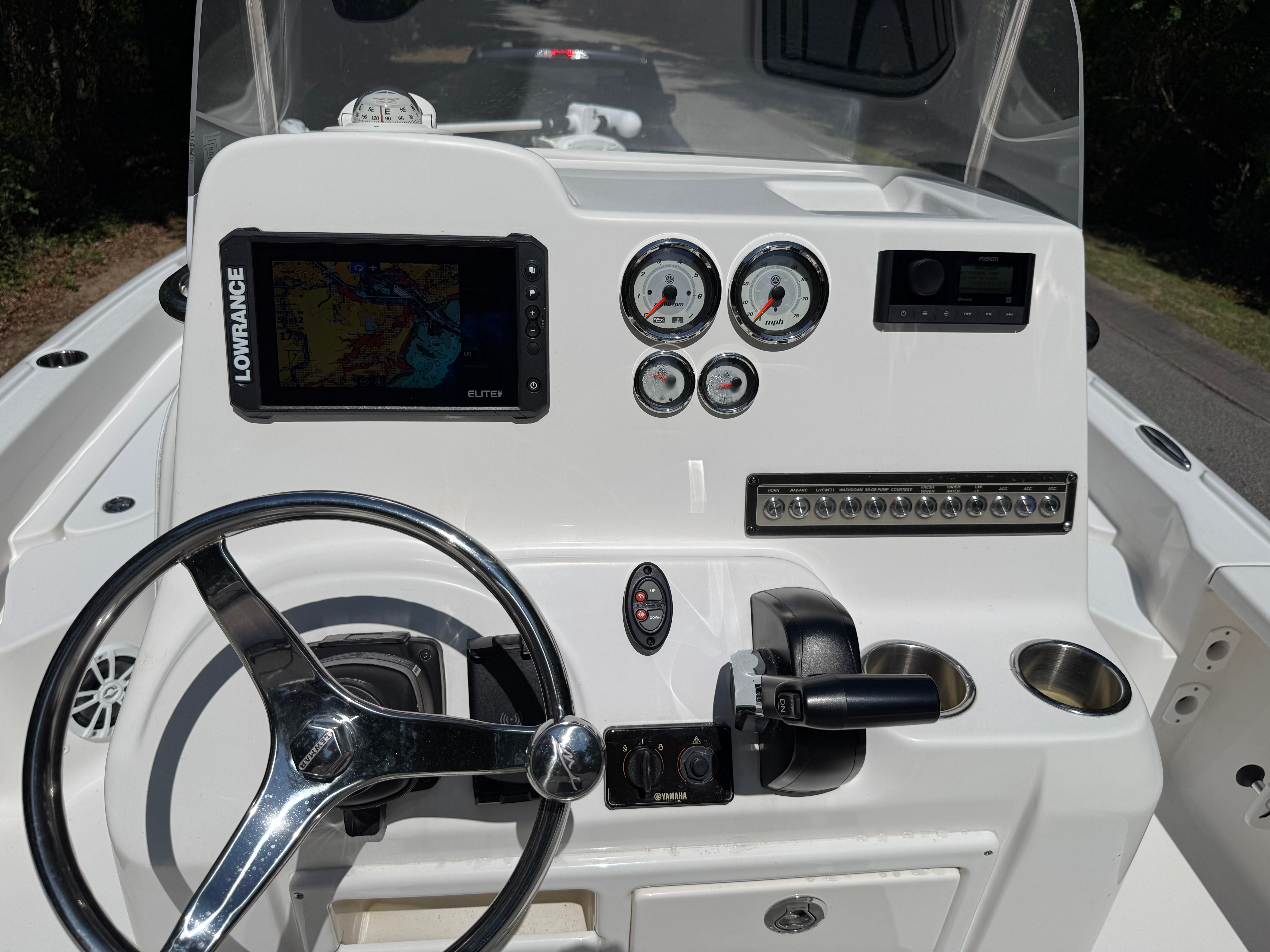 The image shows the helm of a 2023 Tidewater 2210 Carolina Bay boat with modern instruments.