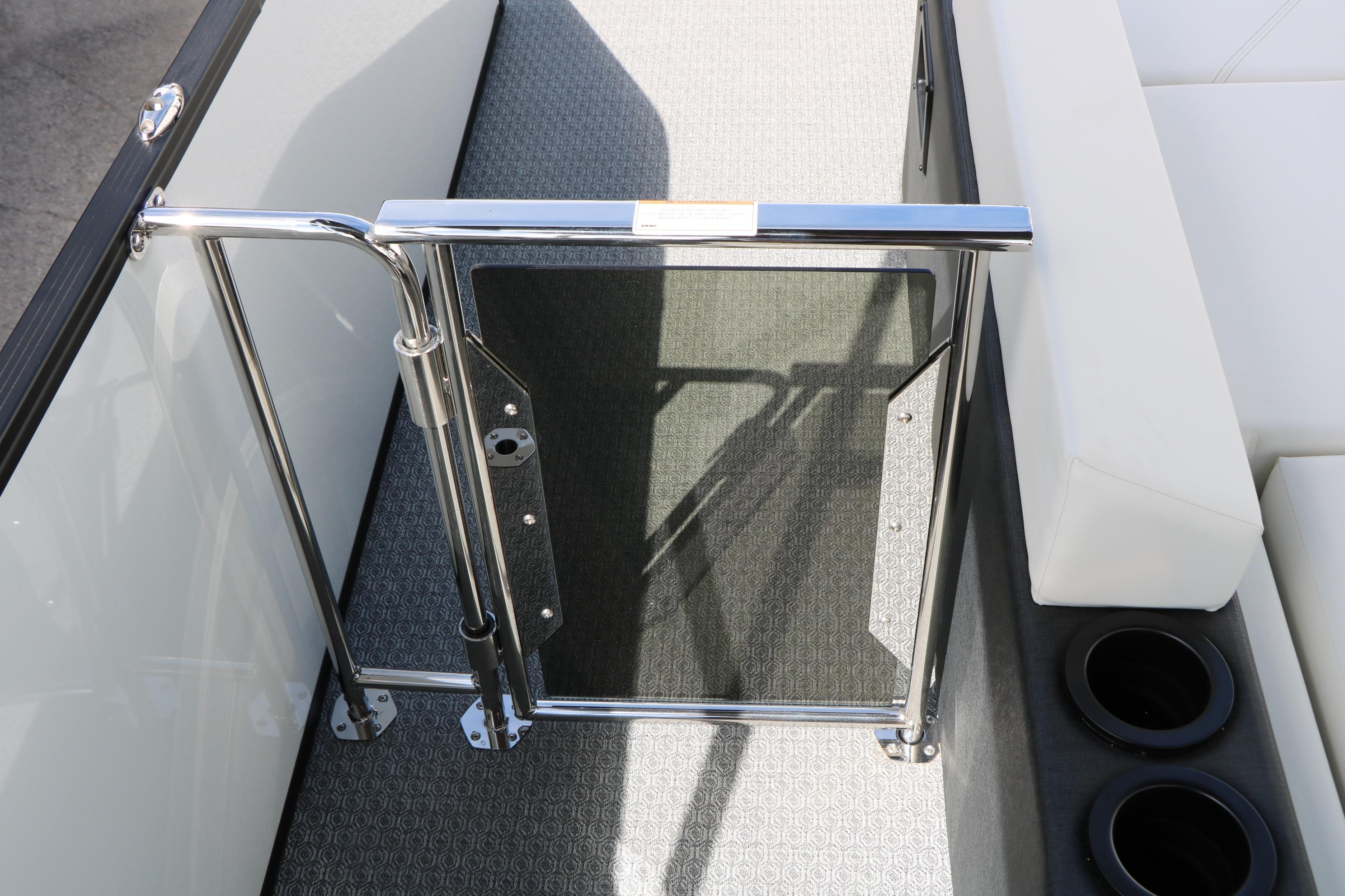 Interior view of 2026 Evotti 725 CS Tri-Toon boat with gate and seating.
