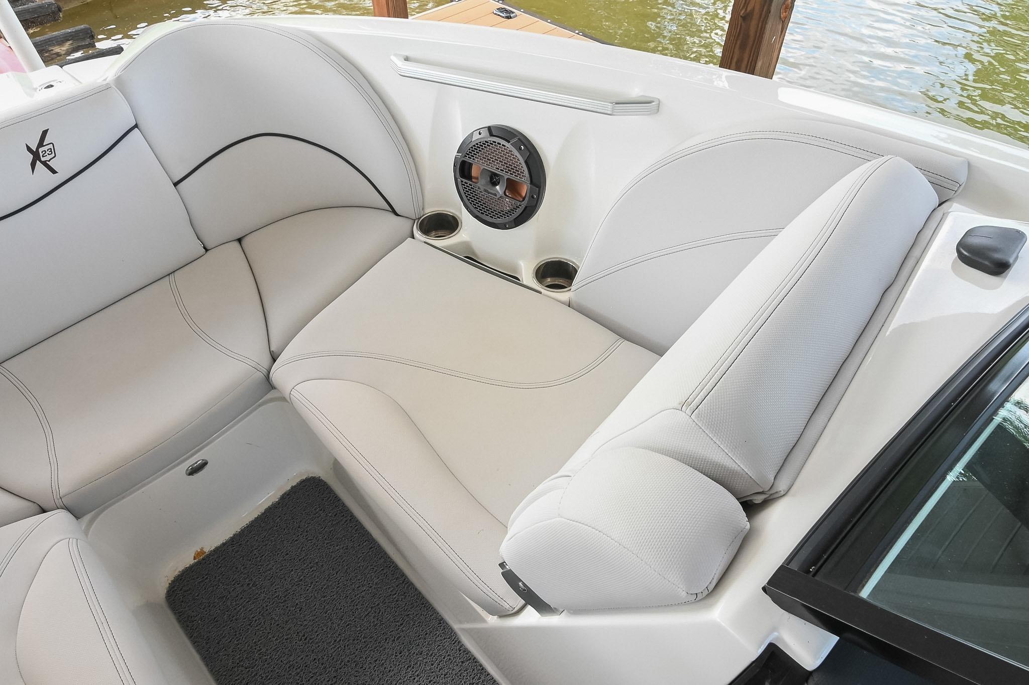 2018 MasterCraft X23 boat interior with white seating and speaker detail.