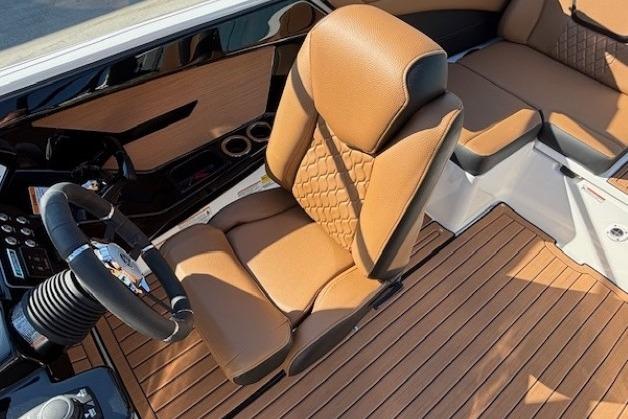 2026 Yamaha Boats 222SE interior with tan leather seats and wood-style flooring.
