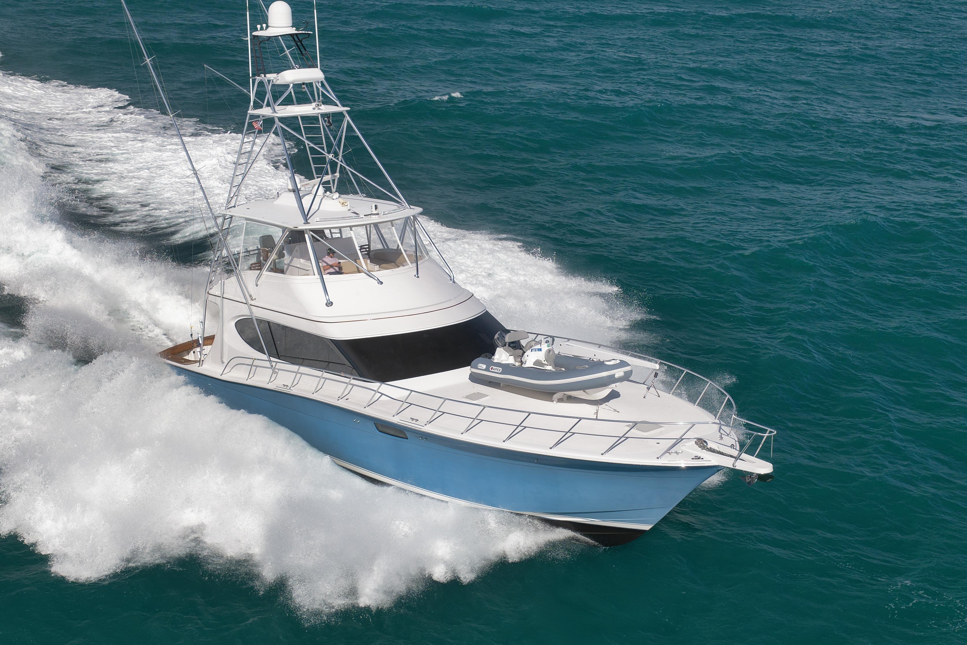 2015 Hatteras GT70 yacht cruising on open ocean waters.
