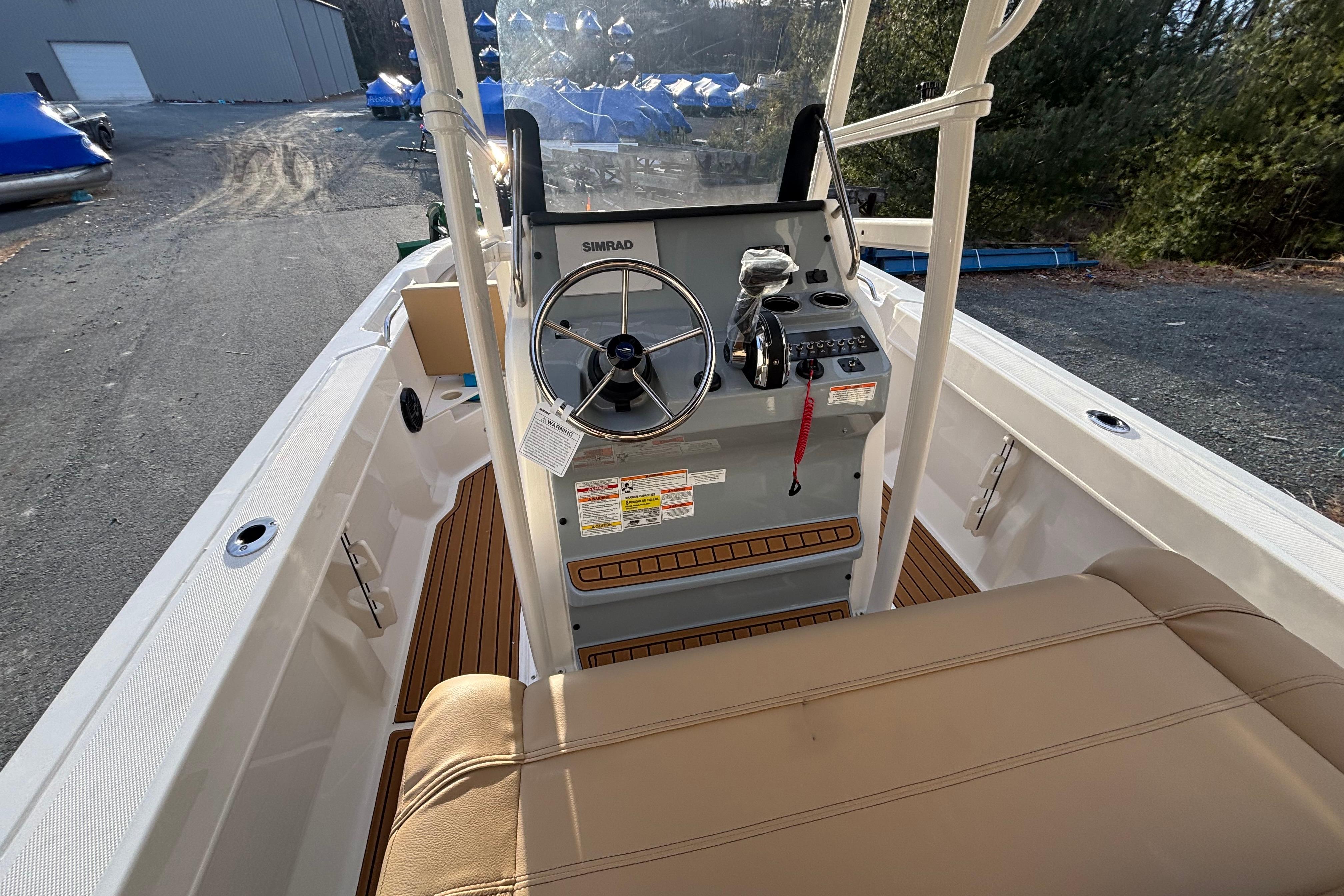 2026 Bayliner Trophy T20CC boat interior with steering console and seating.
