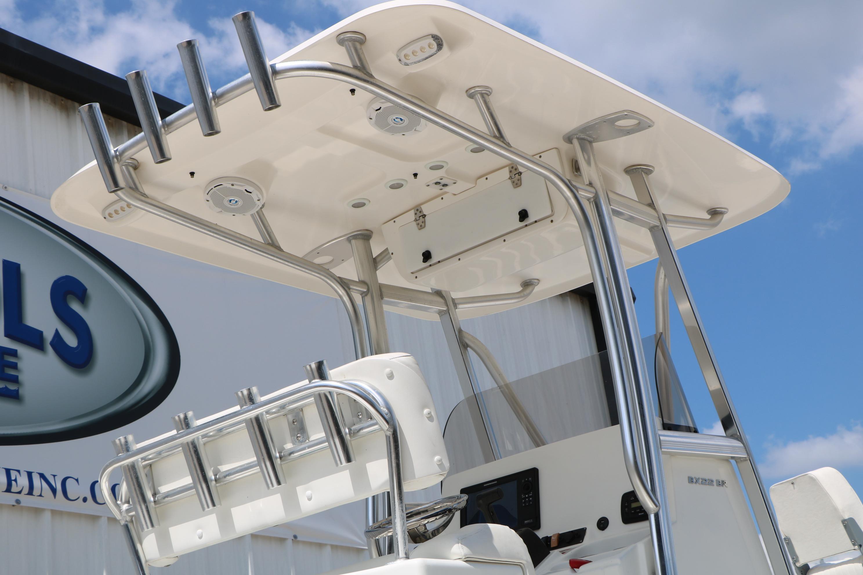 2015 Sea Hunt BX 22 BR boat with T-top and rod holders against blue sky.