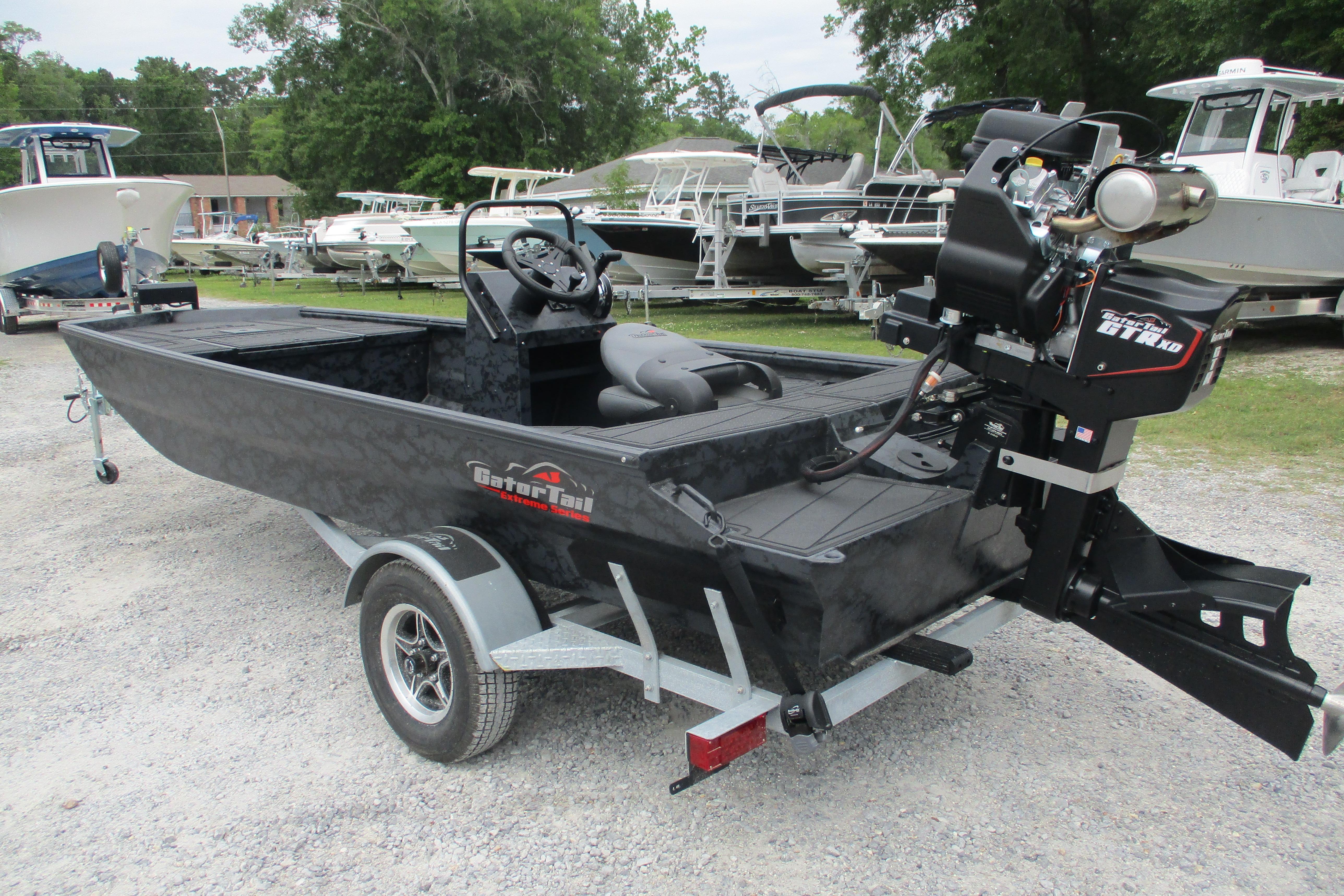 2026 Gator Tail 1860 Extreme CC boat on trailer, parked in a marina lot.
