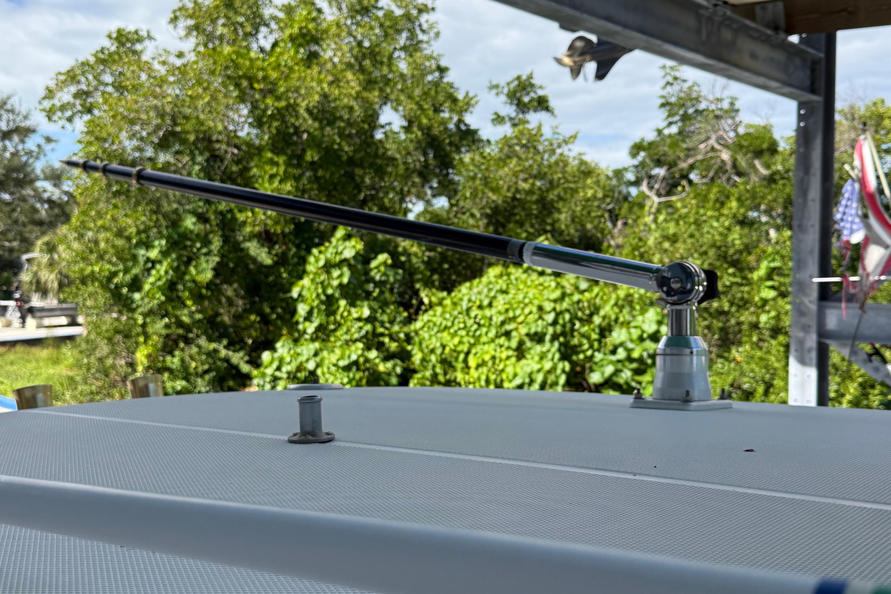 Antenna on 2008 Century 2901 Center Console boat, surrounded by lush greenery.