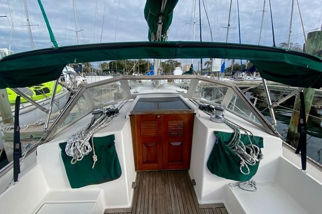 Sailboat cockpit view, Gozard 31 model, 1996, with green canopy and ropes.