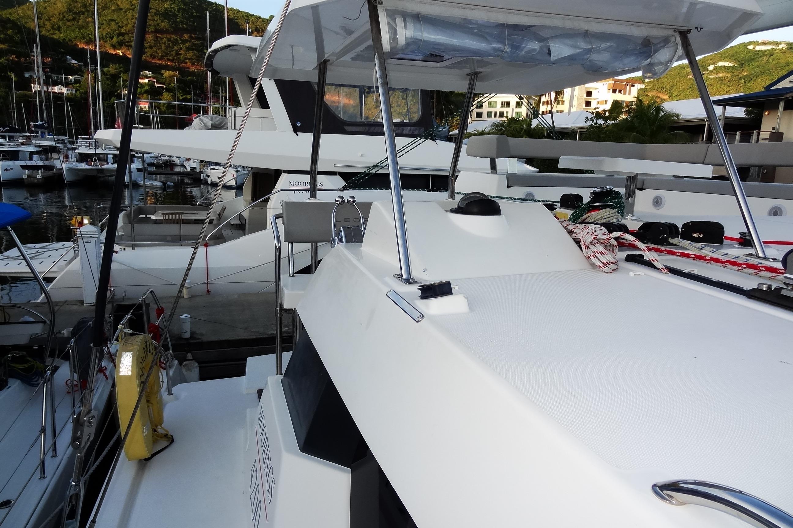 2024 Robertson and Caine Leopard 42 catamaran docked at a marina, showcasing deck and rigging.