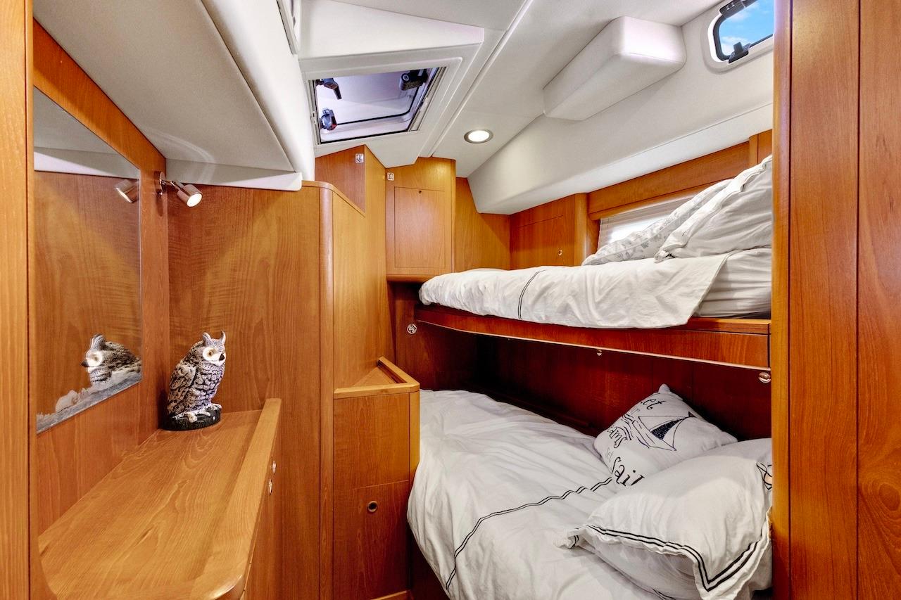 Luxurious wooden cabin interior of 2011 Southerly 57 RS yacht with bunk beds.