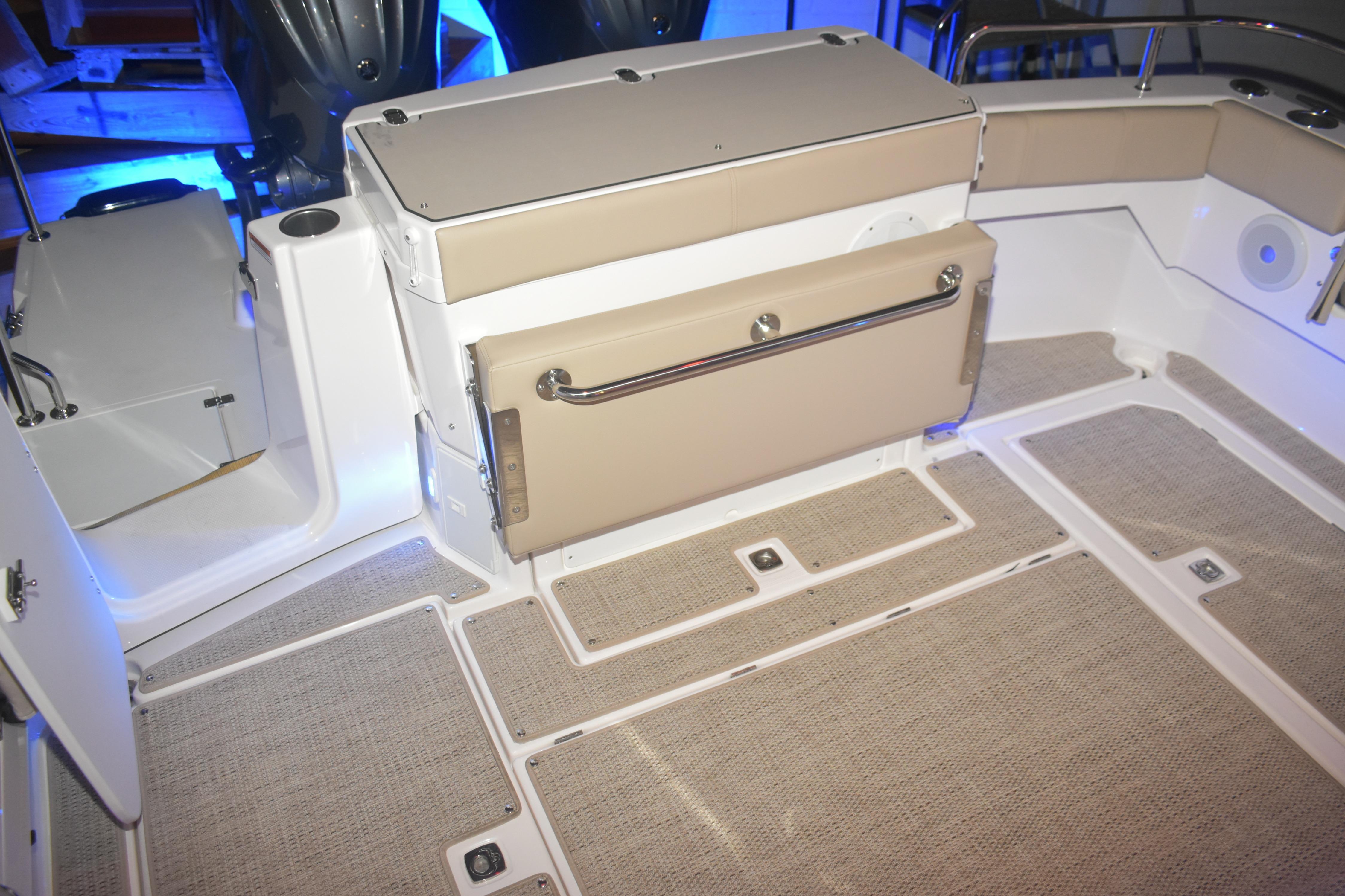 2026 Cutwater C-32 CB boat interior with beige seating and carpeted flooring.