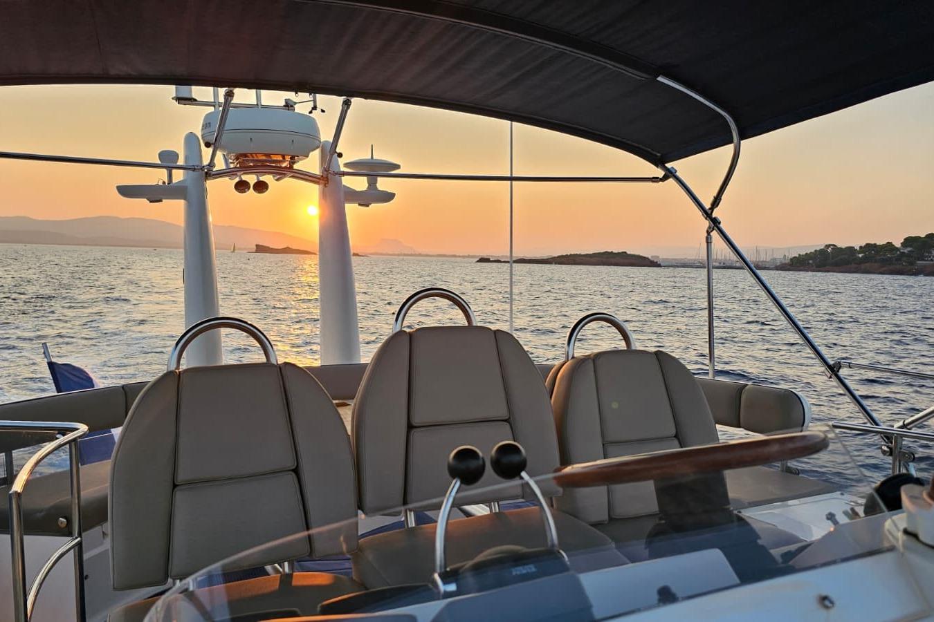 2001 Fairline Squadron 52 yacht at sunset, featuring elegant helm and scenic ocean view.