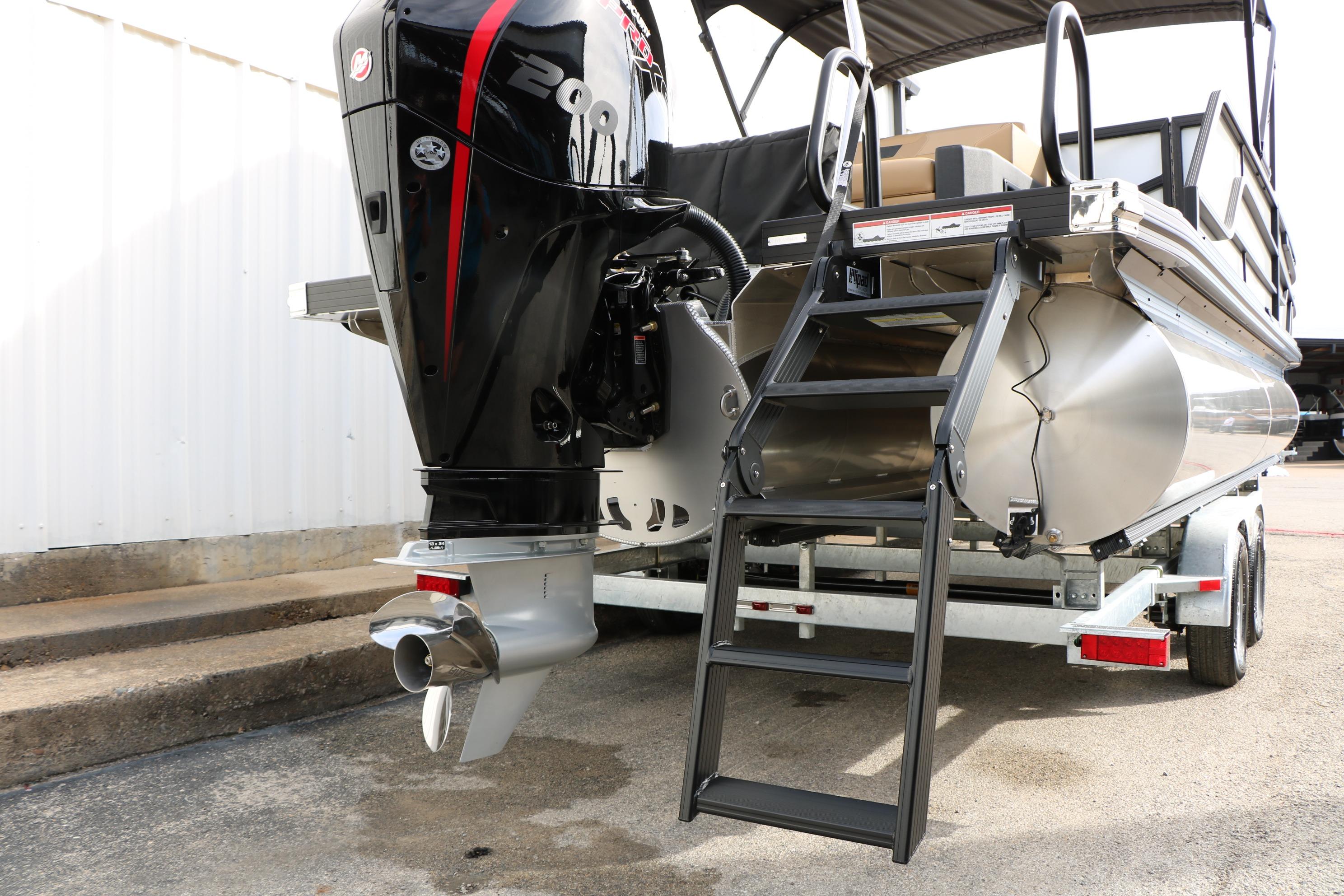 Rear view of 2026 Evotti 523CS boat with powerful outboard motor and boarding ladder.