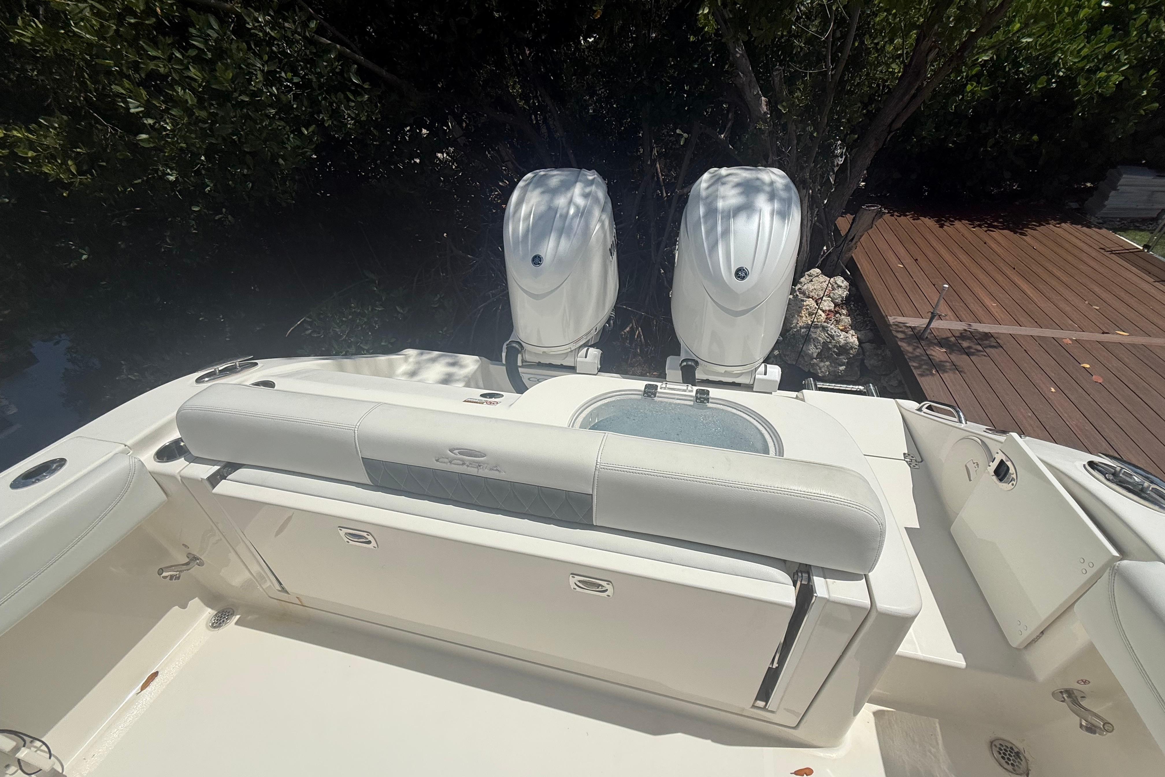 2024 Cobia 280 Center Console boat with dual engines and spacious seating area.