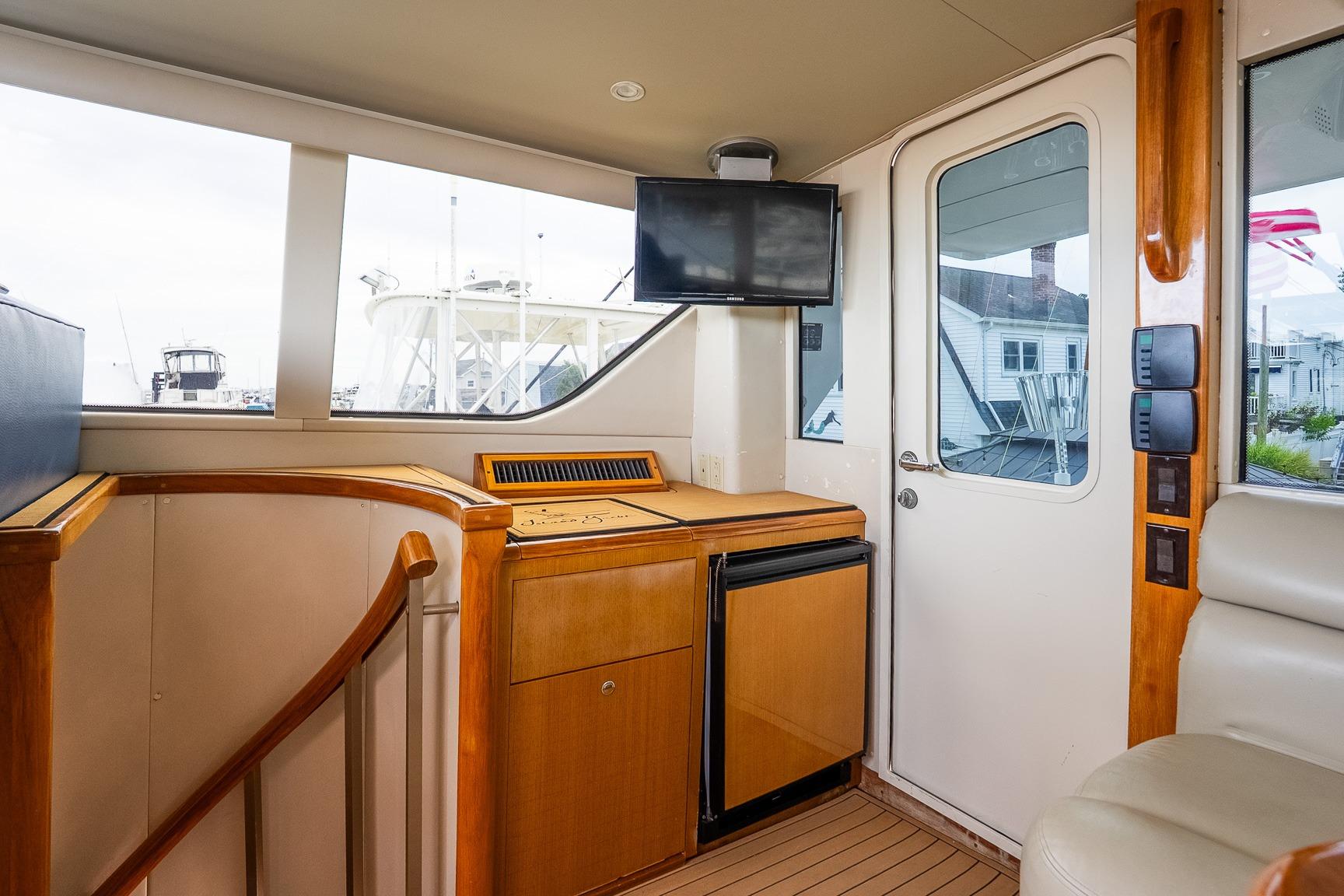 Interior of a 2002 Viking 61 Enclosed Bridge yacht with wood accents and modern amenities.
