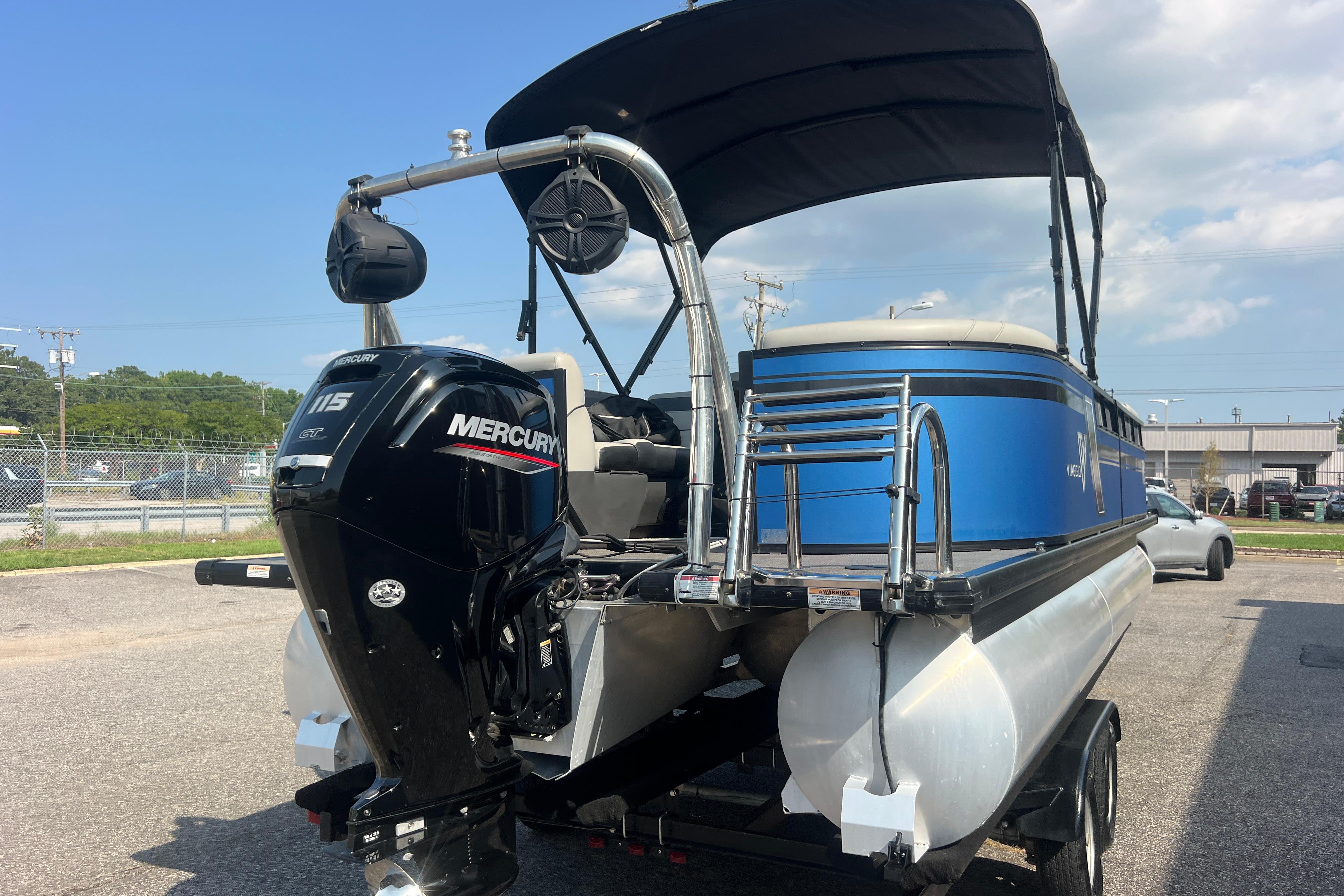 2022 Viaggio Lago V-U 22 pontoon boat with Mercury 115 engine, parked outdoors.