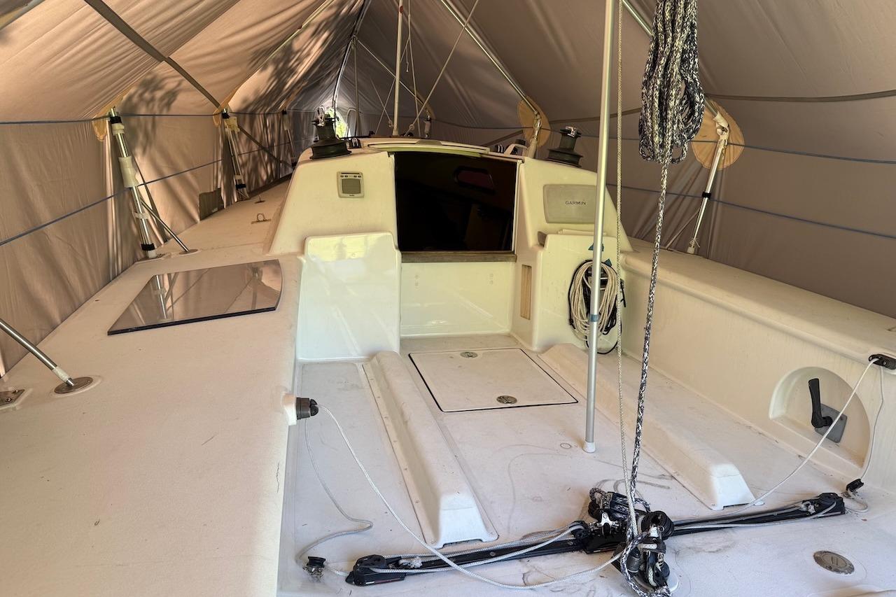 2007 Hallett 33 sailboat interior under a protective tent, showcasing deck and rigging.