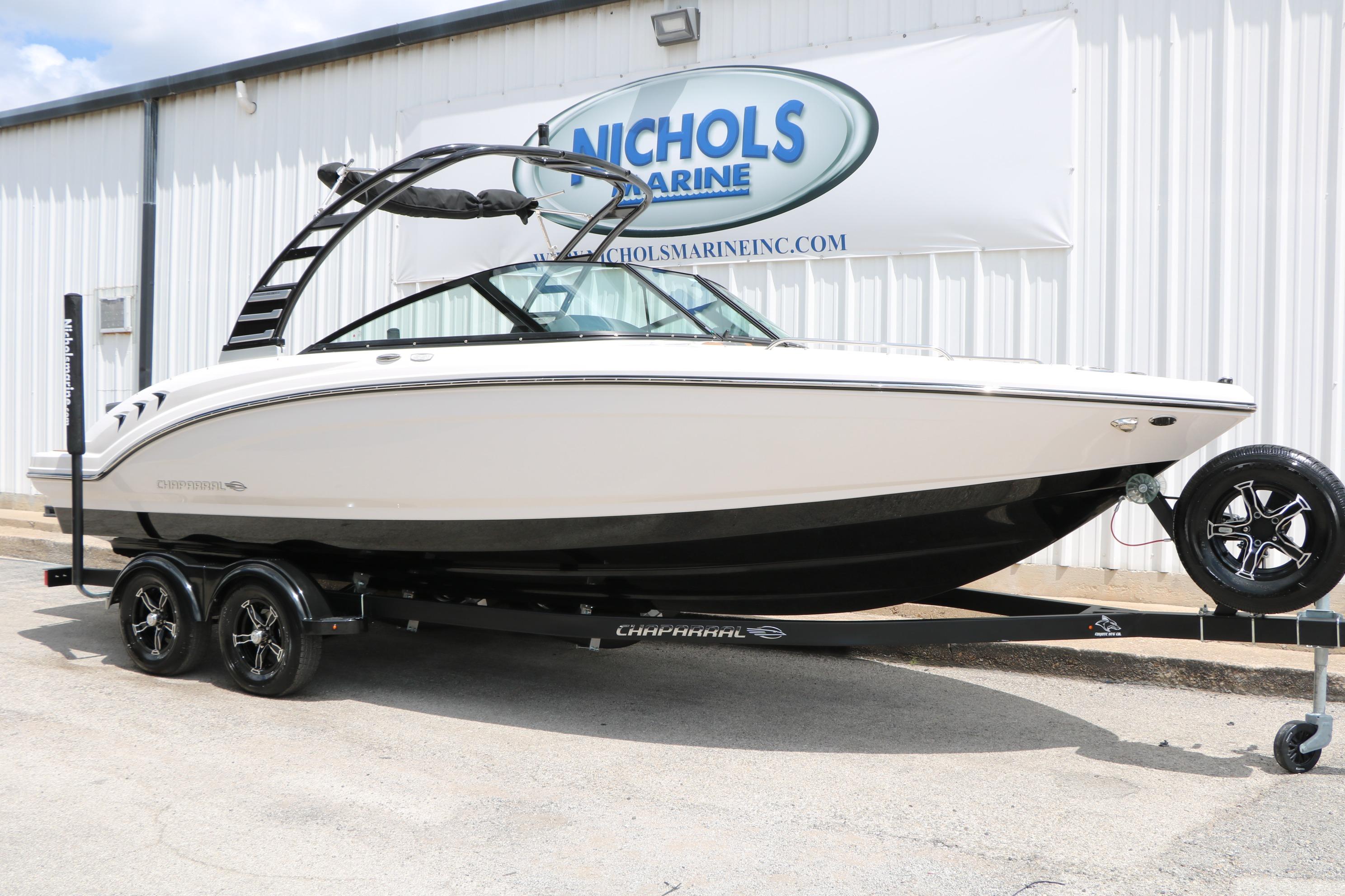 2025 Chaparral 23 SSi boat on trailer at Nichols Marine dealership.