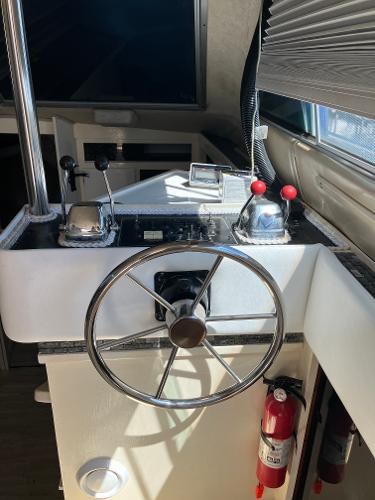 1985 Cruisers Yachts 338 Chateau Vee helm station with steering wheel and controls.