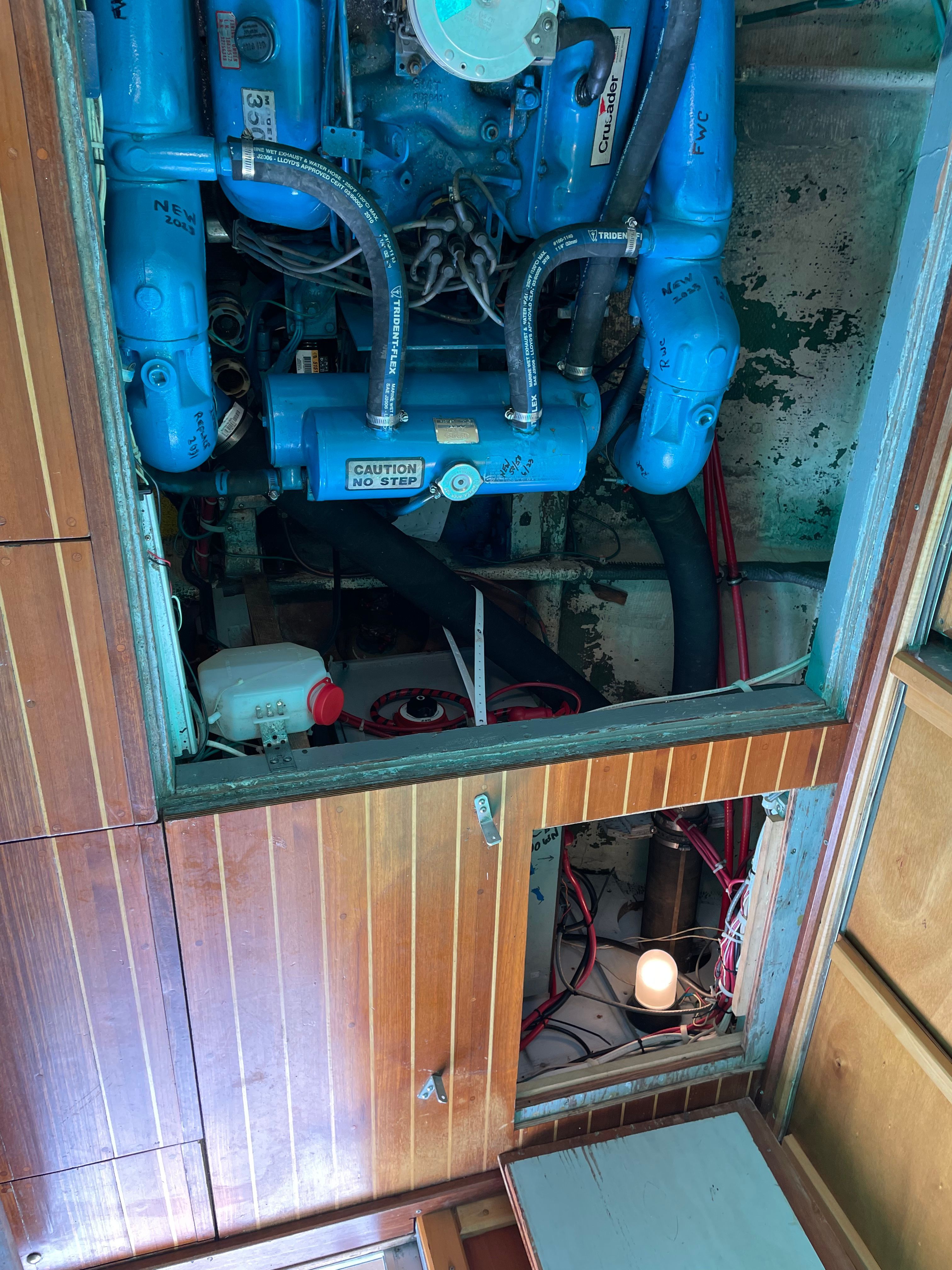 Engine room of a 1969 Bertram Caribe boat with blue engine.