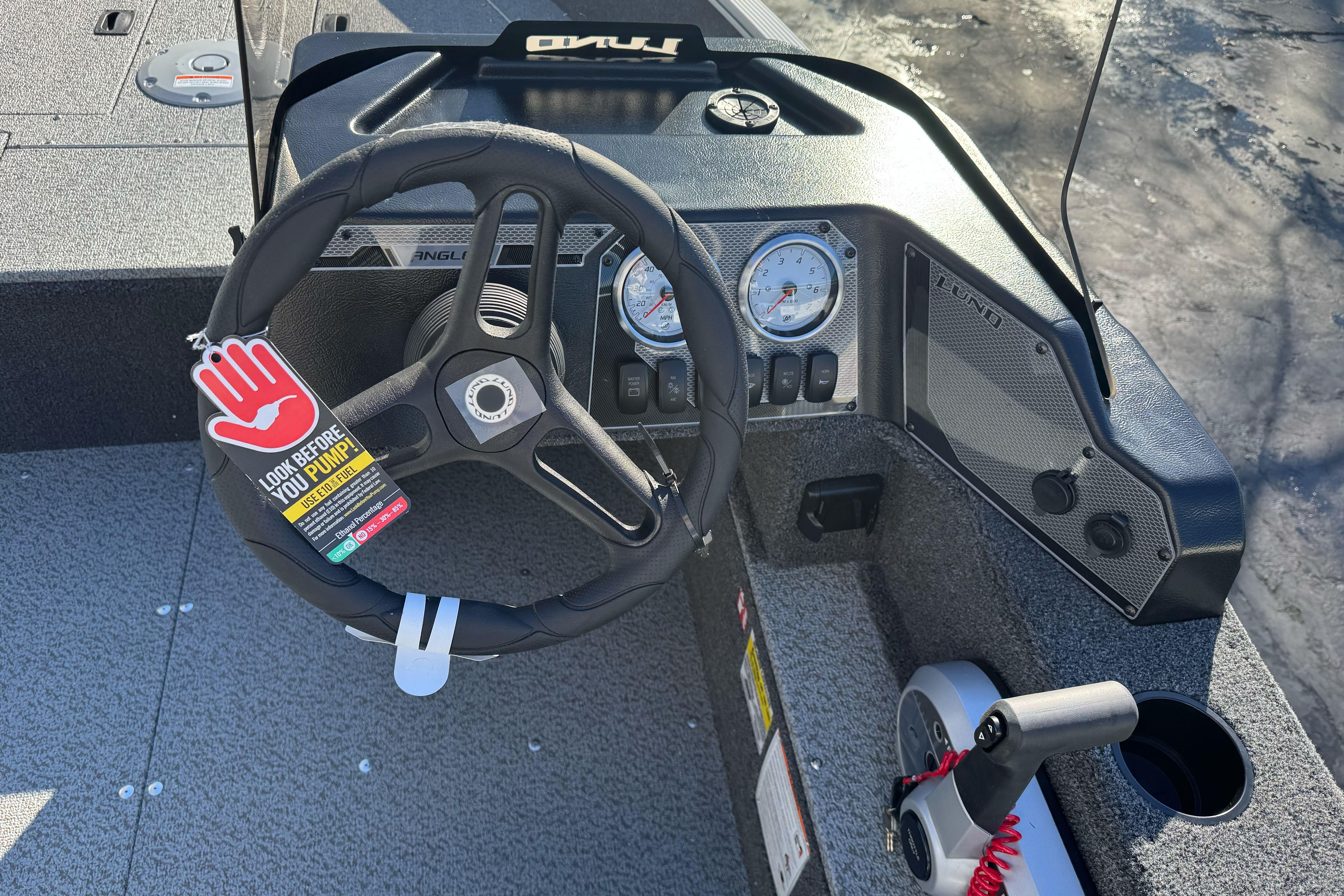 2026 Lund 1650 Angler SS boat dashboard with steering wheel and gauges.