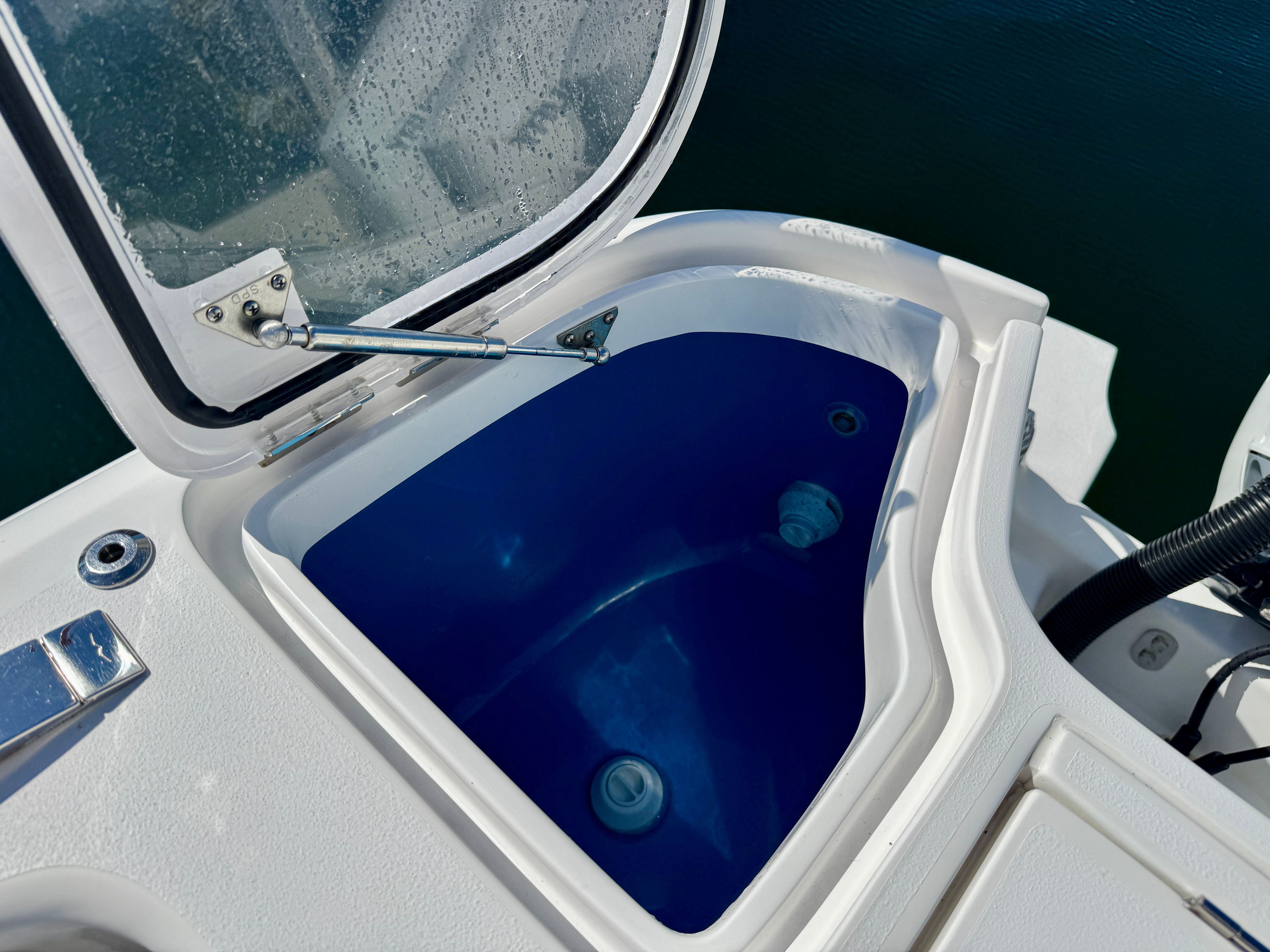 2024 Intrepid 407 Nomad FE boat with open storage compartment.