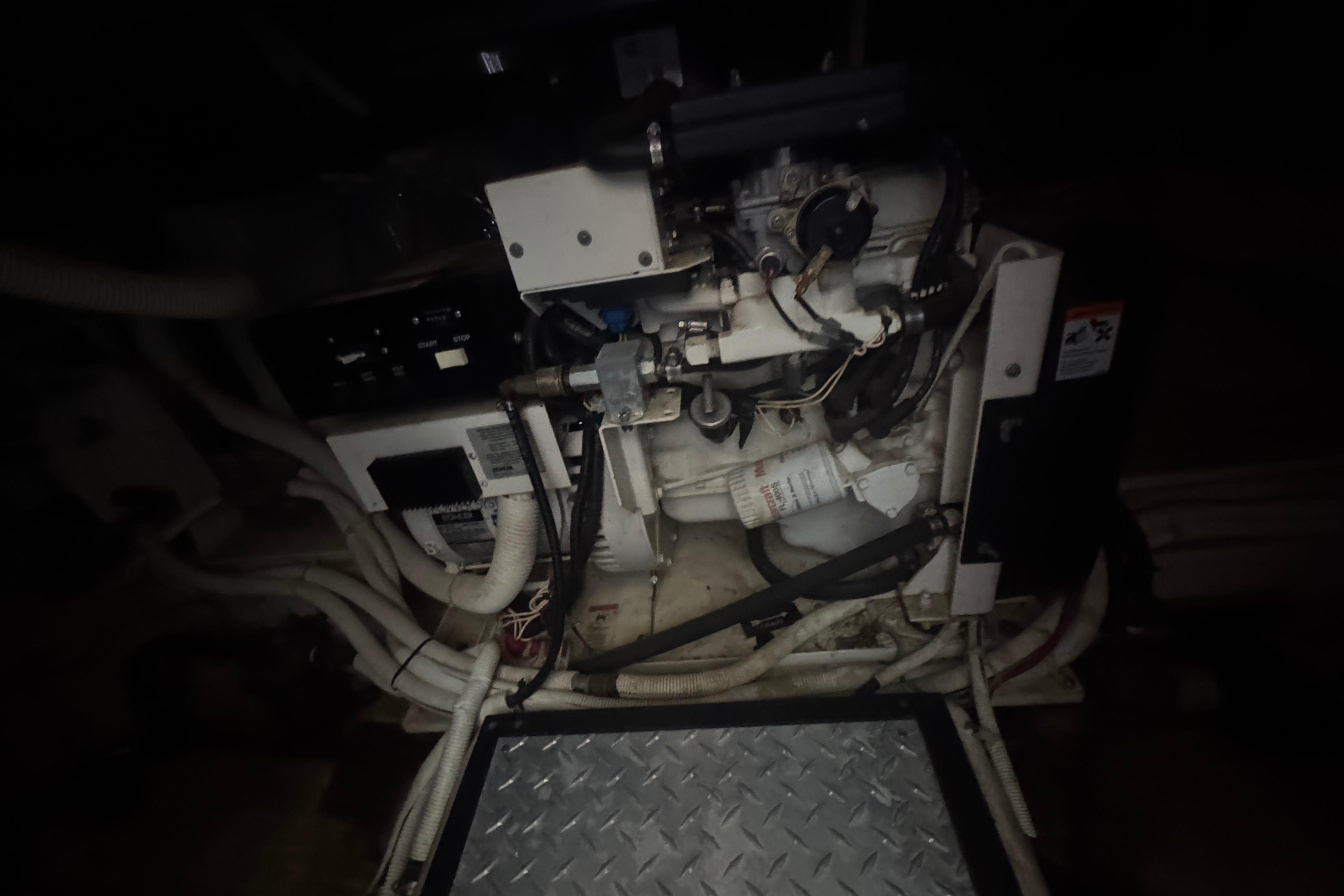 Engine room of 2002 Carver 396 Motor Yacht with visible machinery and wiring.