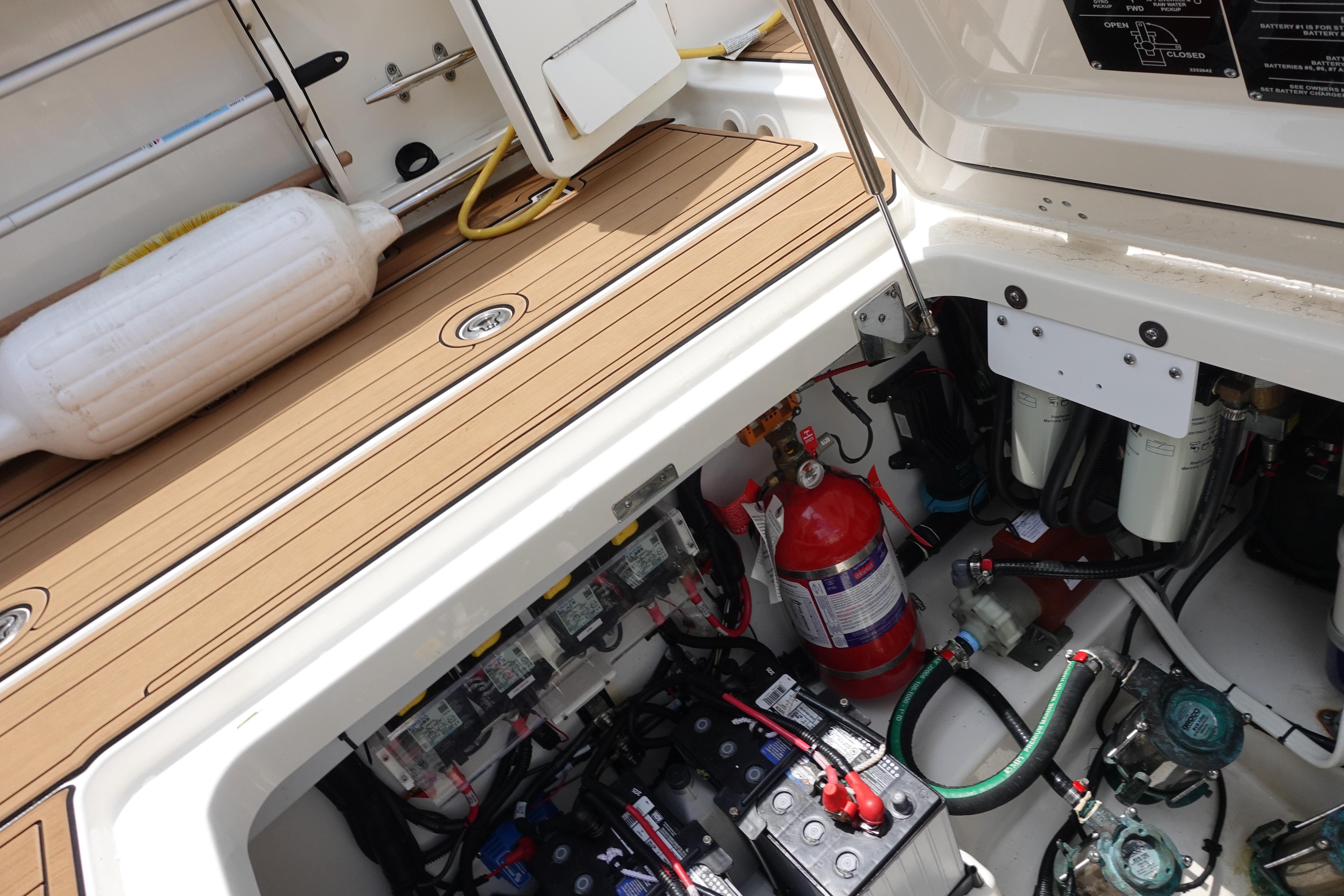 2020 Boston Whaler 420 Outrage engine compartment with equipment and fire extinguisher.