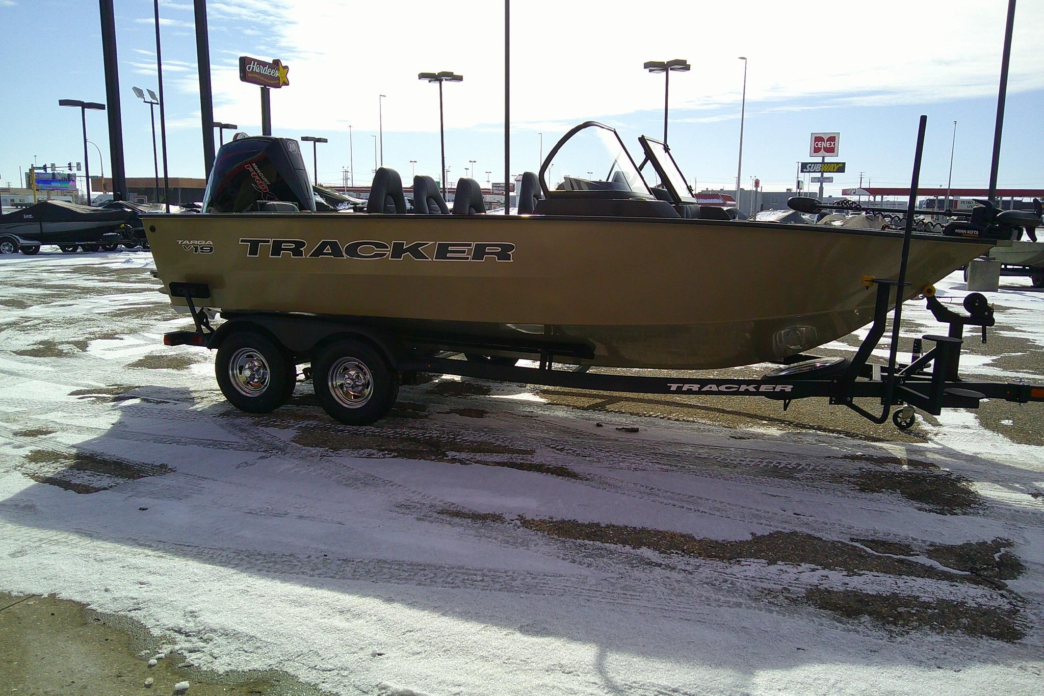 2026 Tracker Targa V-19 Combo boat on trailer in snowy parking lot.