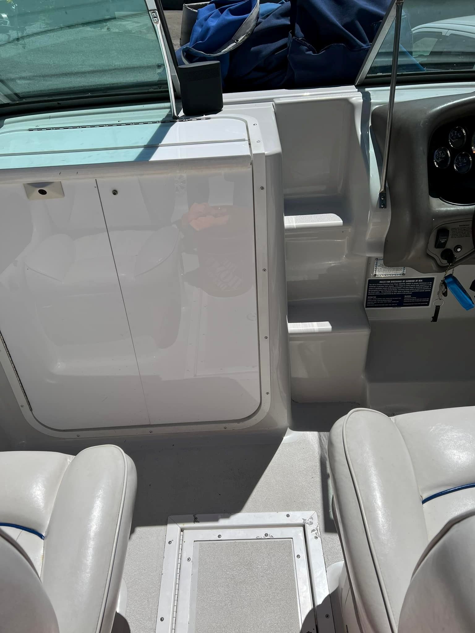 Interior of a 1999 Crownline 266 CCR boat with seats and control panel.