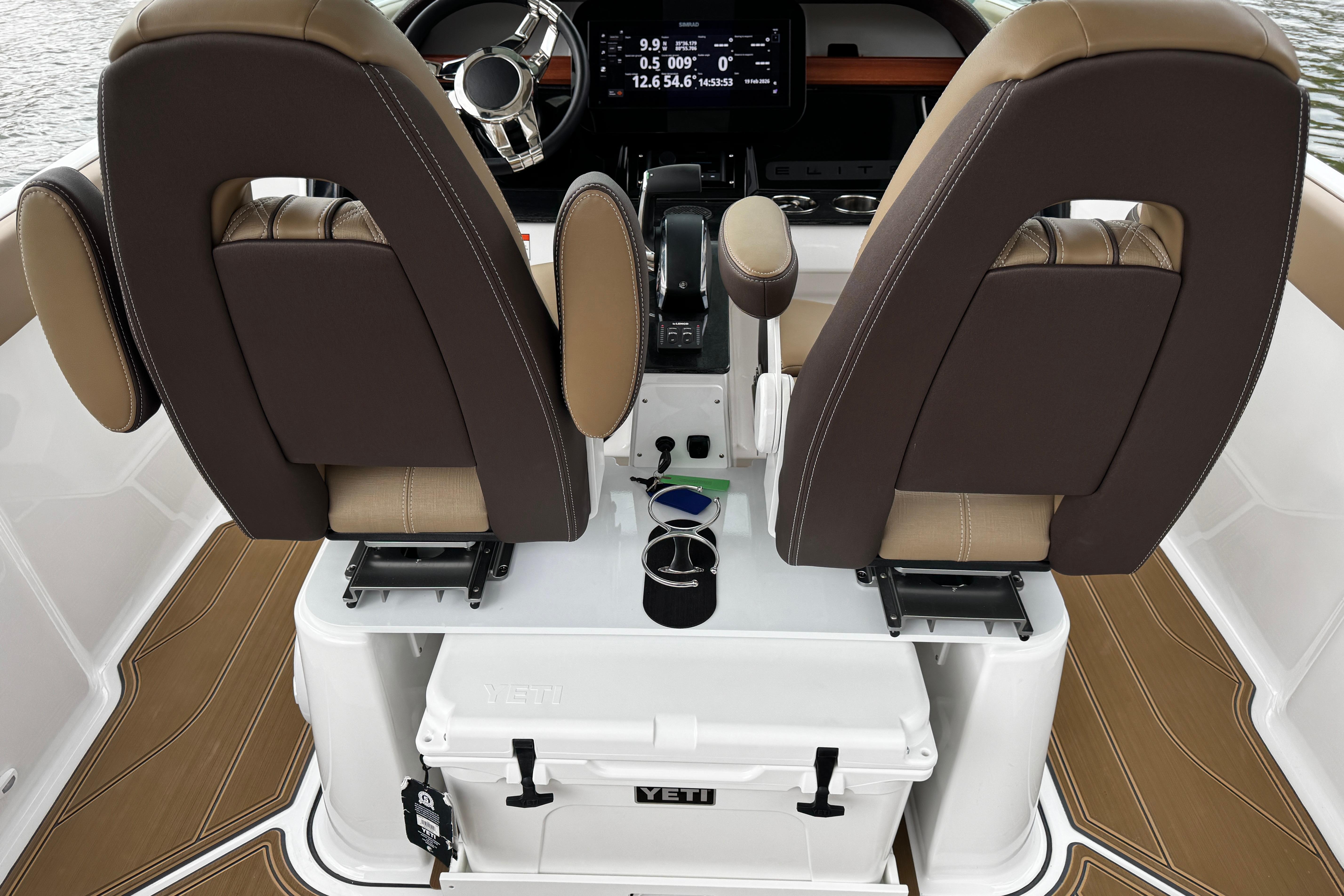 2026 Monterey Elite 25 OB boat interior with dual brown seats and Yeti cooler.