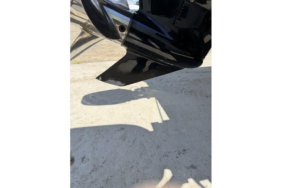 Close-up of a 2016 Triton 216 Fishunter boat motor component on a sunny day.