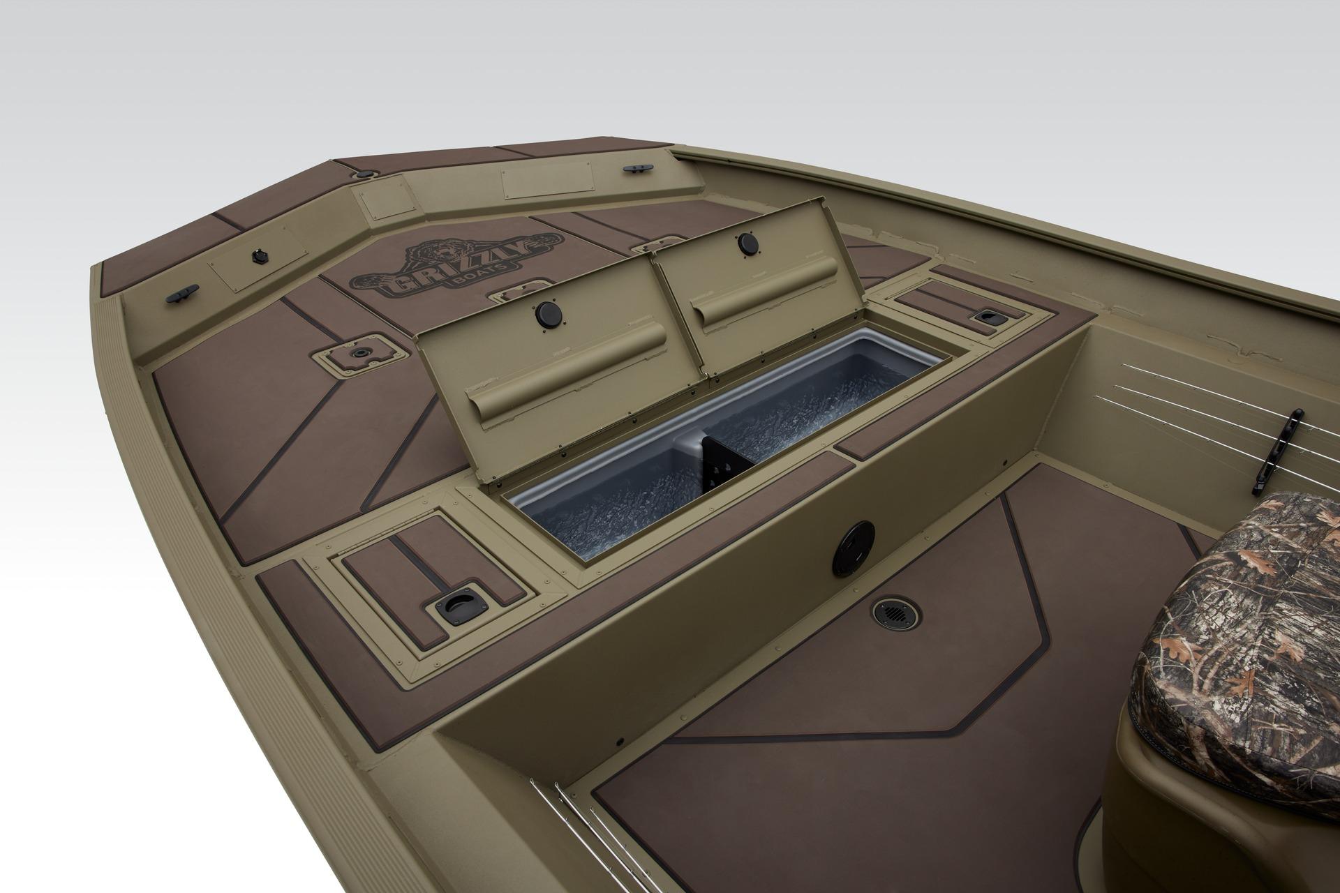 2024 Tracker Grizzly 2072 CC boat interior with storage compartments and camo seat.