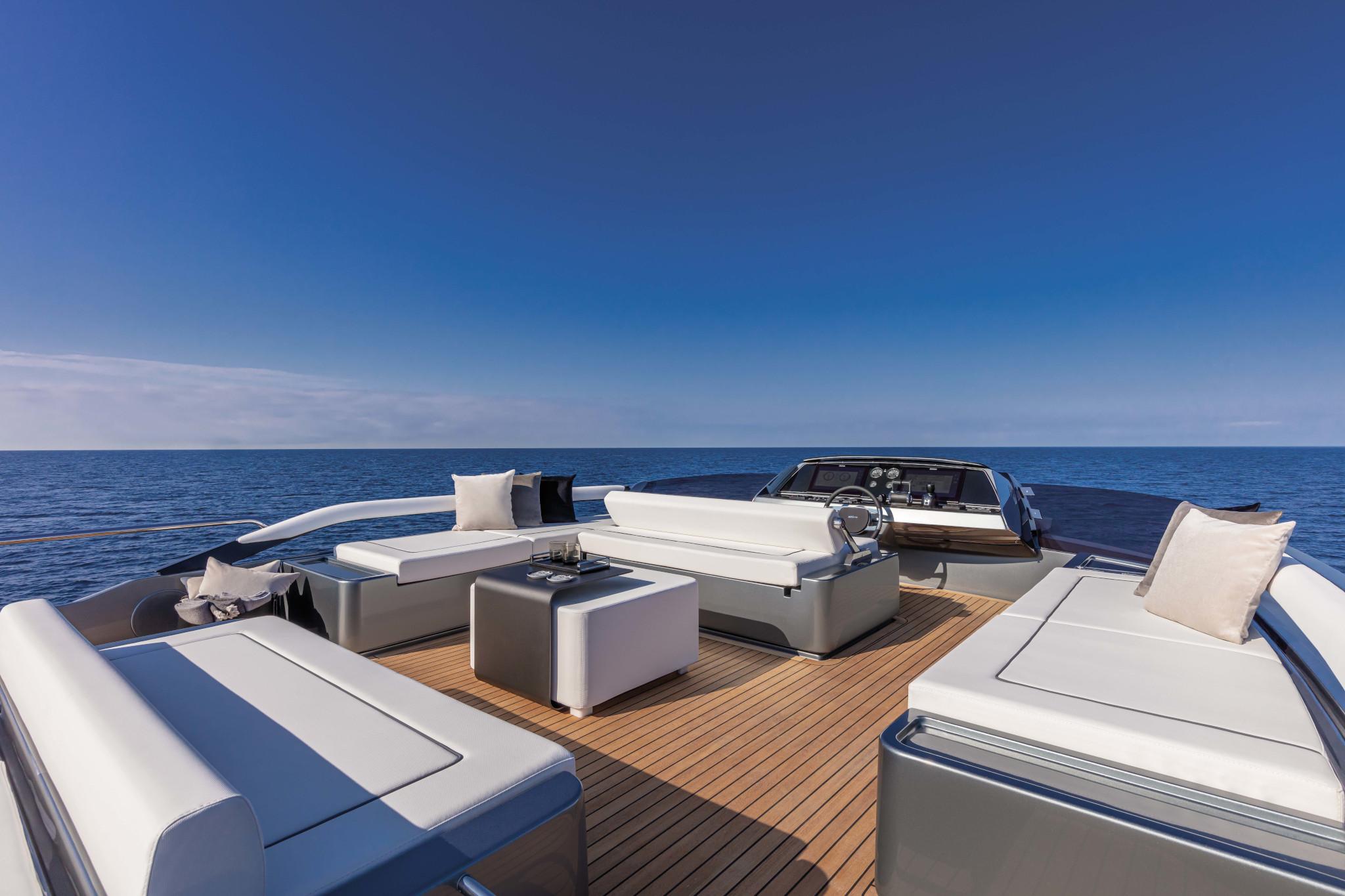 Luxurious 2025 Riva Folgore yacht deck with elegant seating, overlooking the serene ocean.