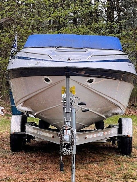 1999 Crownline 266 CCR boat on trailer outdoors.