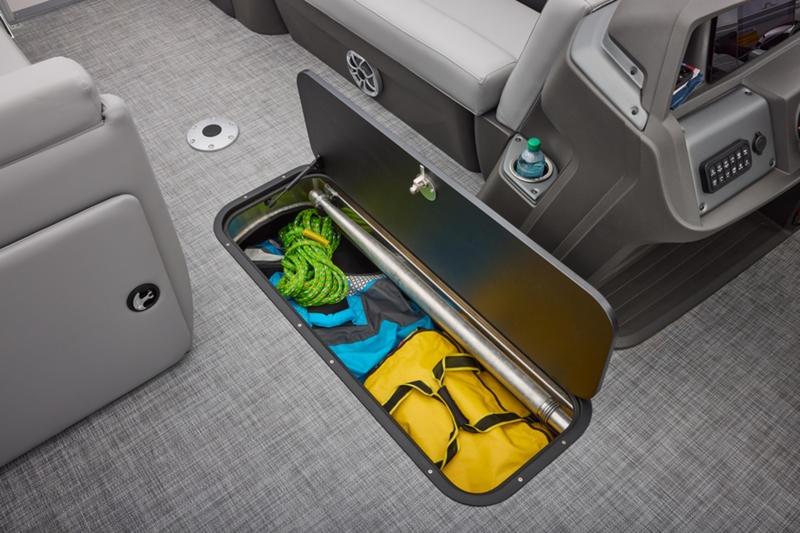 Storage compartment on 2026 Sun Tracker Party Barge 22 DLX with gear and accessories.